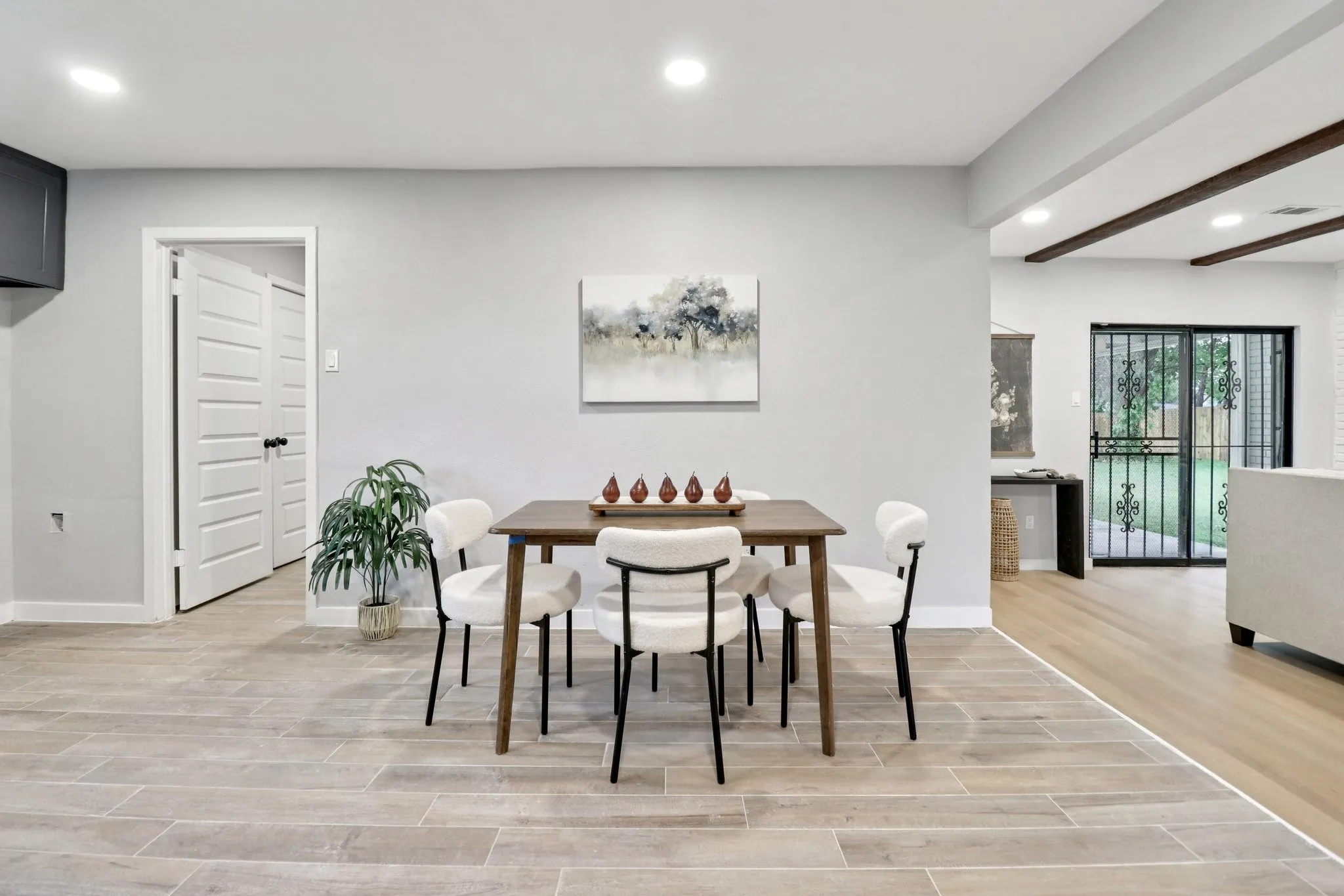 Open concept dining area featuring light gray walls, wood-finish flooring, recessed lighting, and white baseboards
