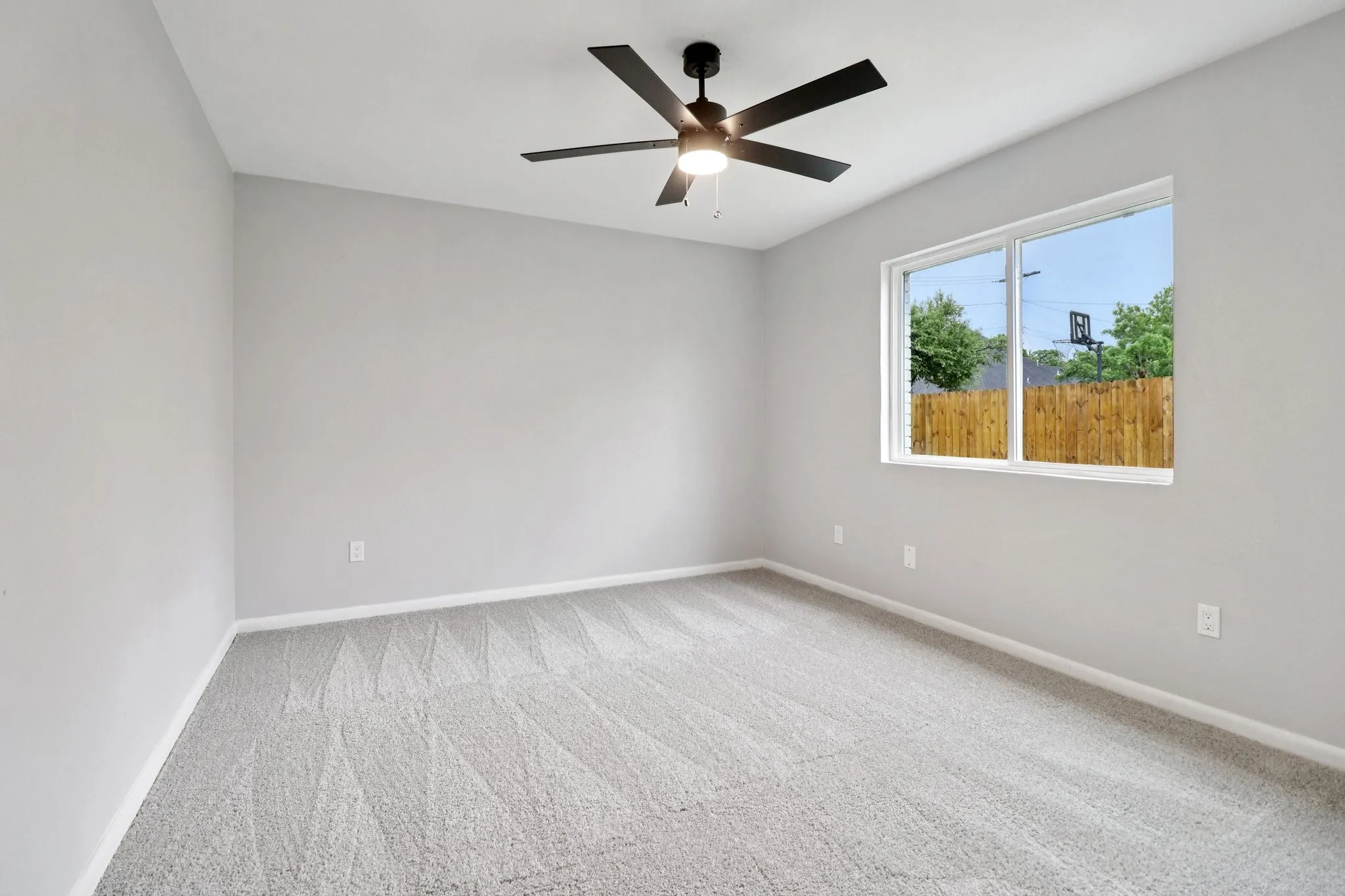 Room featuring light gray carpet, white baseboards, and neutral wall paint