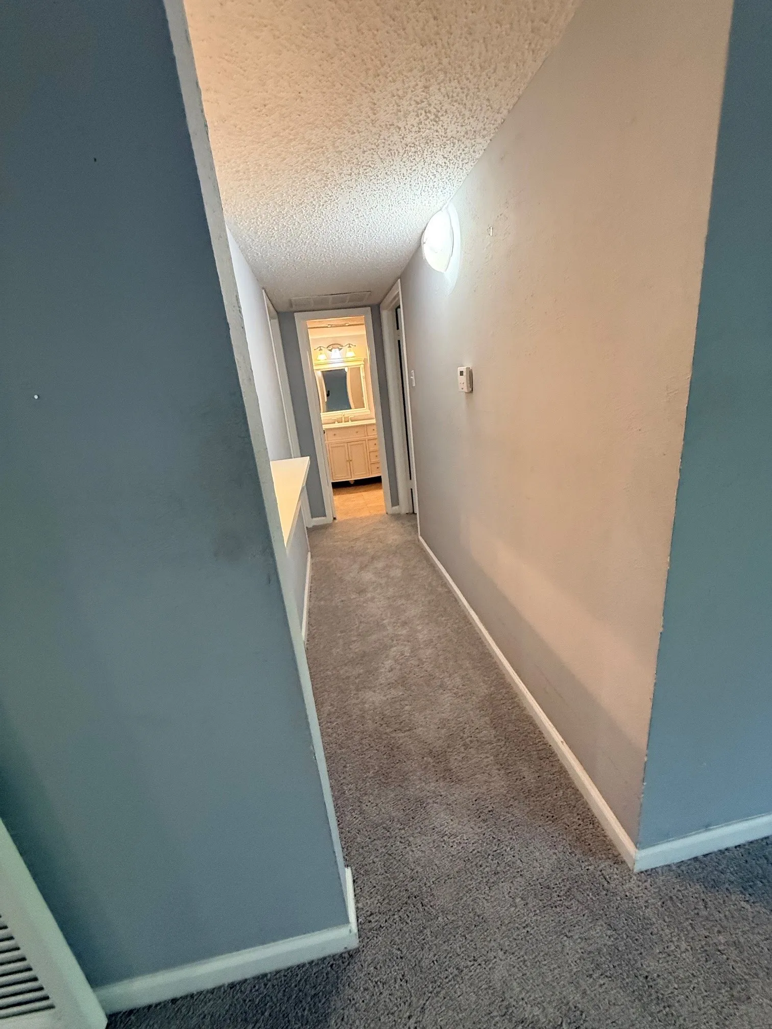 Hallway featuring neutral carpet flooring and light gray walls
