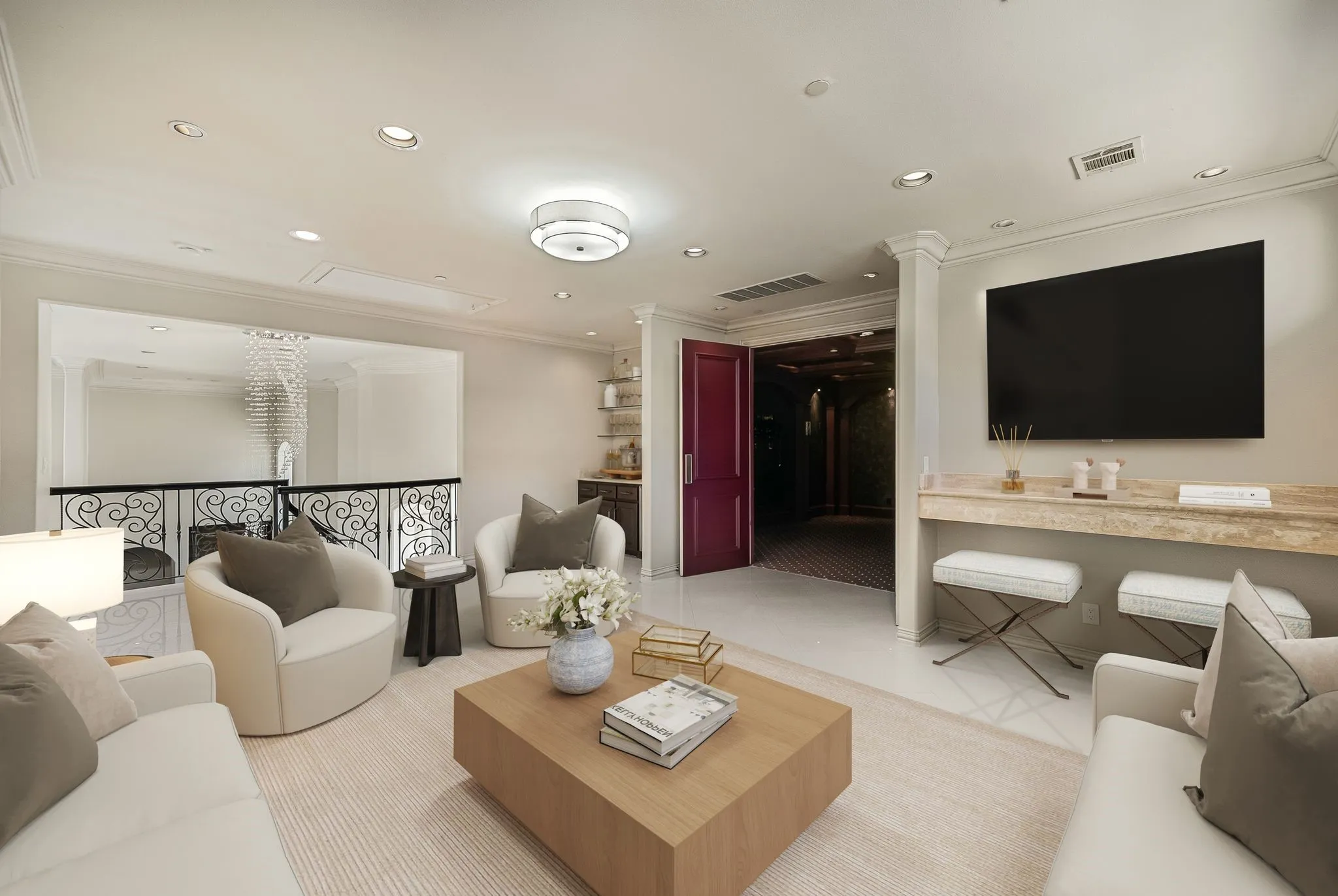 Brightly lit living area featuring recessed lighting, crown molding, and a built-in media console with a stone countertop