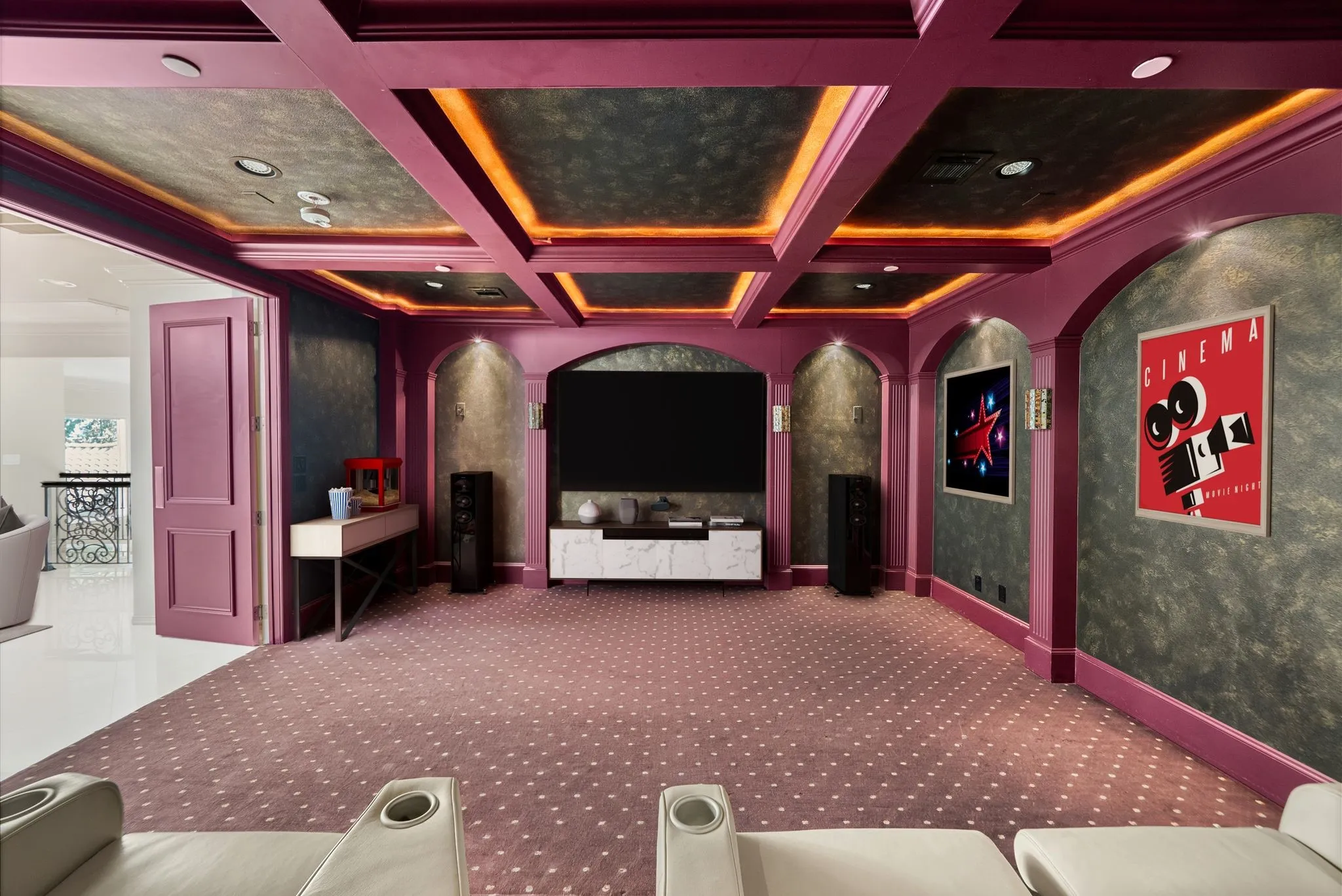 Dedicated media room featuring patterned carpet, recessed lighting, and a coffered ceiling with accent lighting