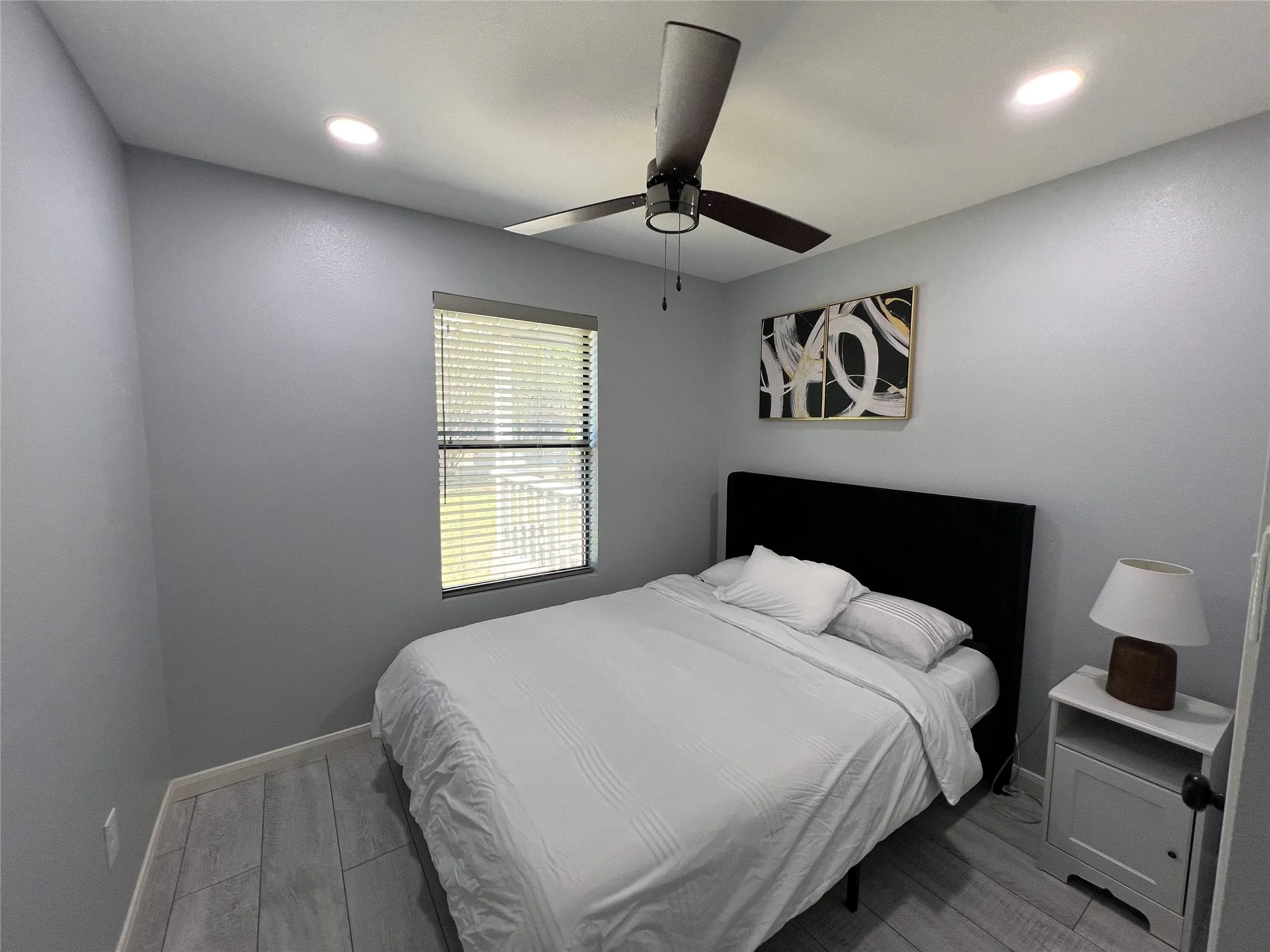 Neutral gray walls complemented by wood-finish flooring