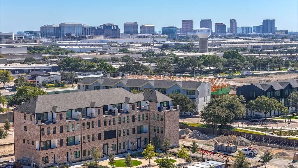 Contemporary multi-story townhomes with brick facades and private balconies