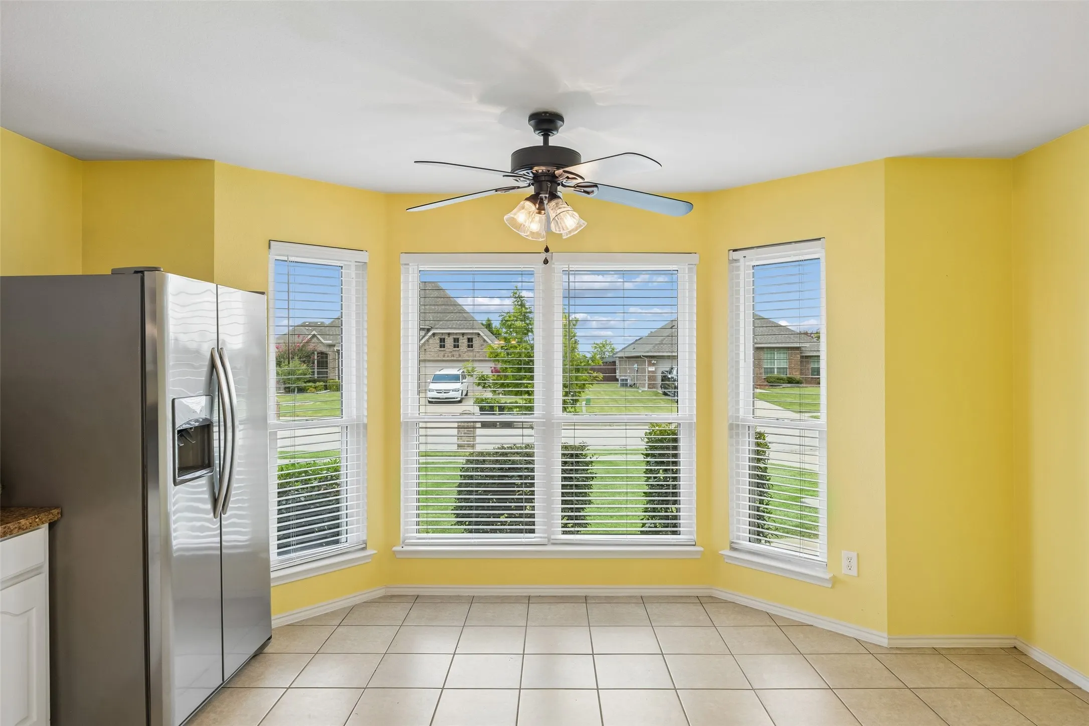 The charming breakfast nook is highlighted by a beautiful bay of windows that welcomes natural light throughout the day.