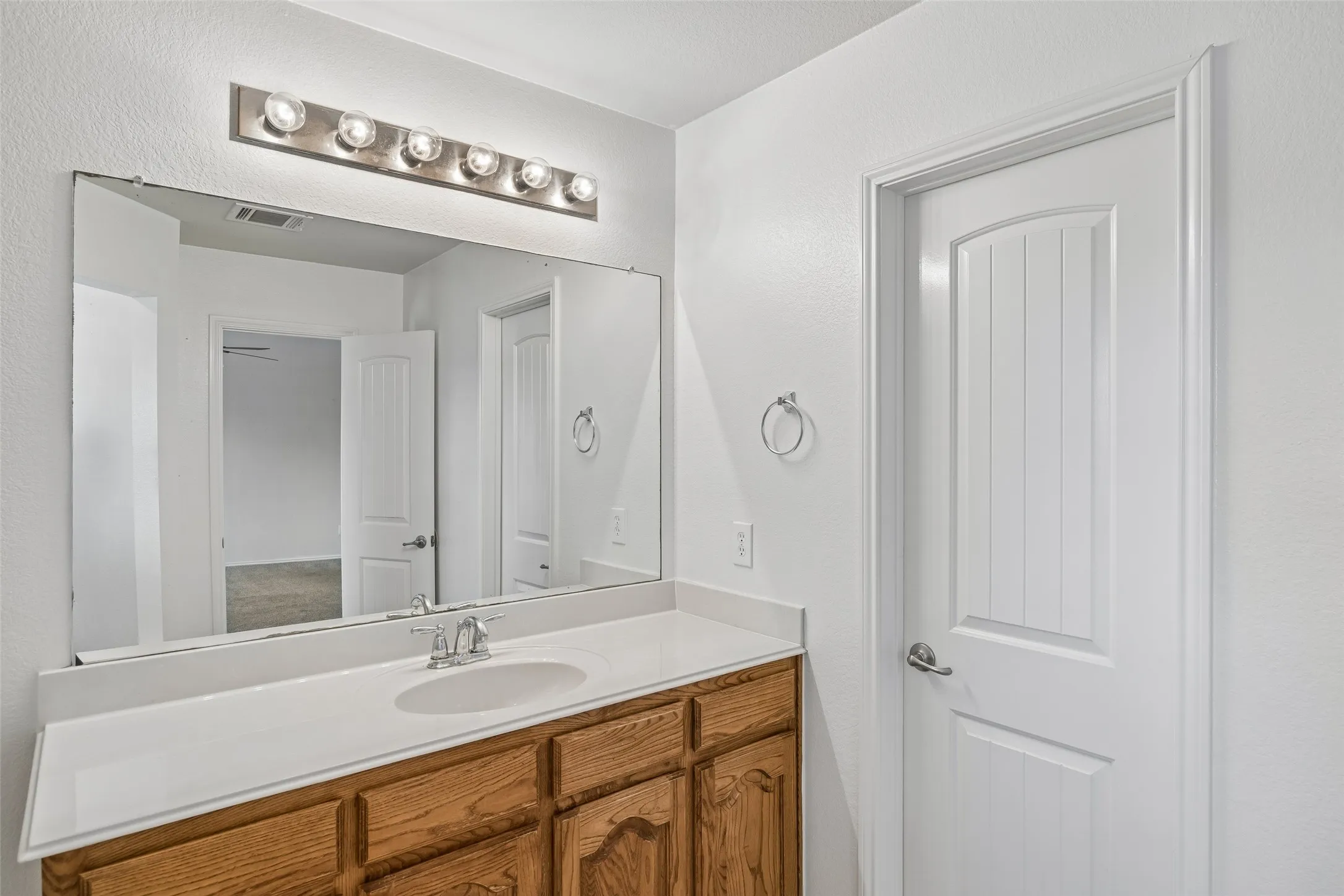 Enjoy plenty of room to get ready with an expansive vanity, abundant storage, and a convenient layout connecting to the walk-in closet.