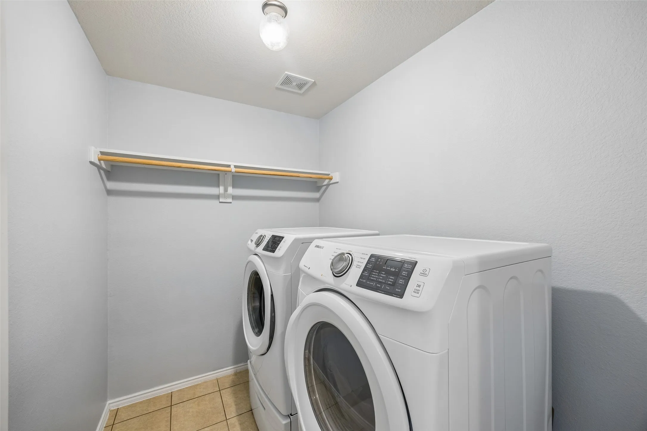 Move-in is even easier with this dedicated laundry room, complete with built-in storage and a washer and dryer that convey with the home.