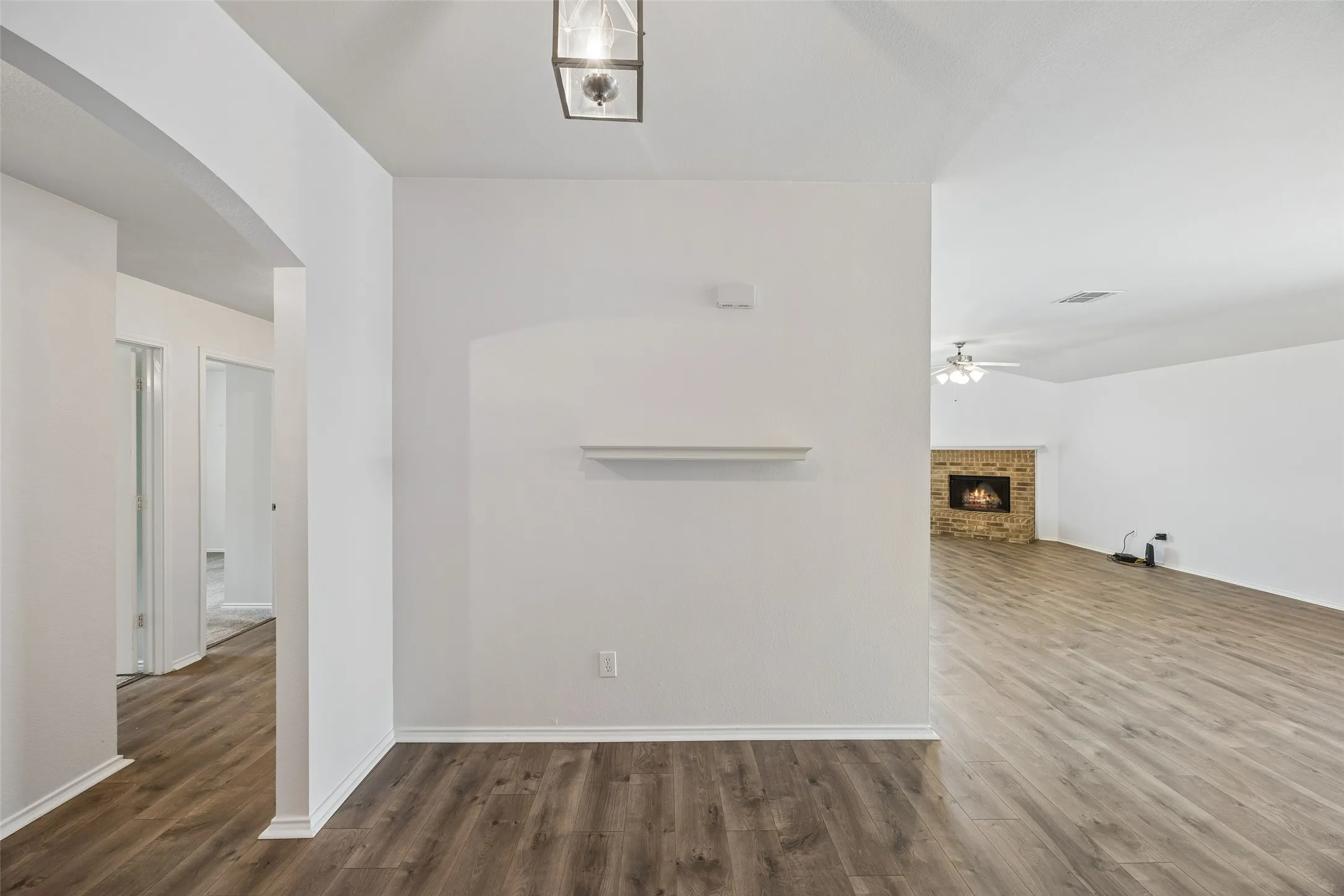 Step inside to a bright, welcoming entry featuring beautiful new flooring and an open-concept layout that flows seamlessly into the main living areas.