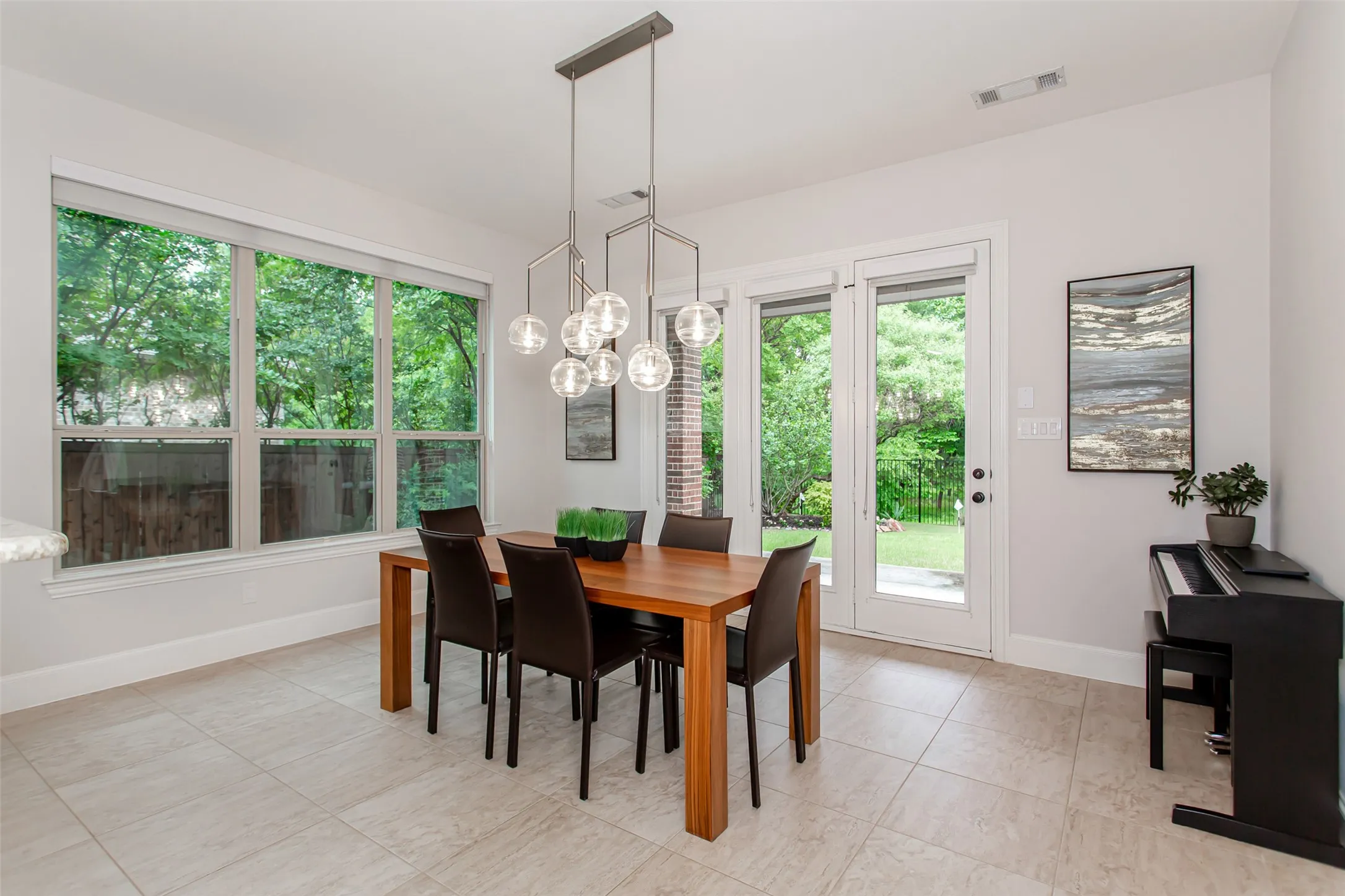 Dining area featuring light-toned tile flooring and white baseboards