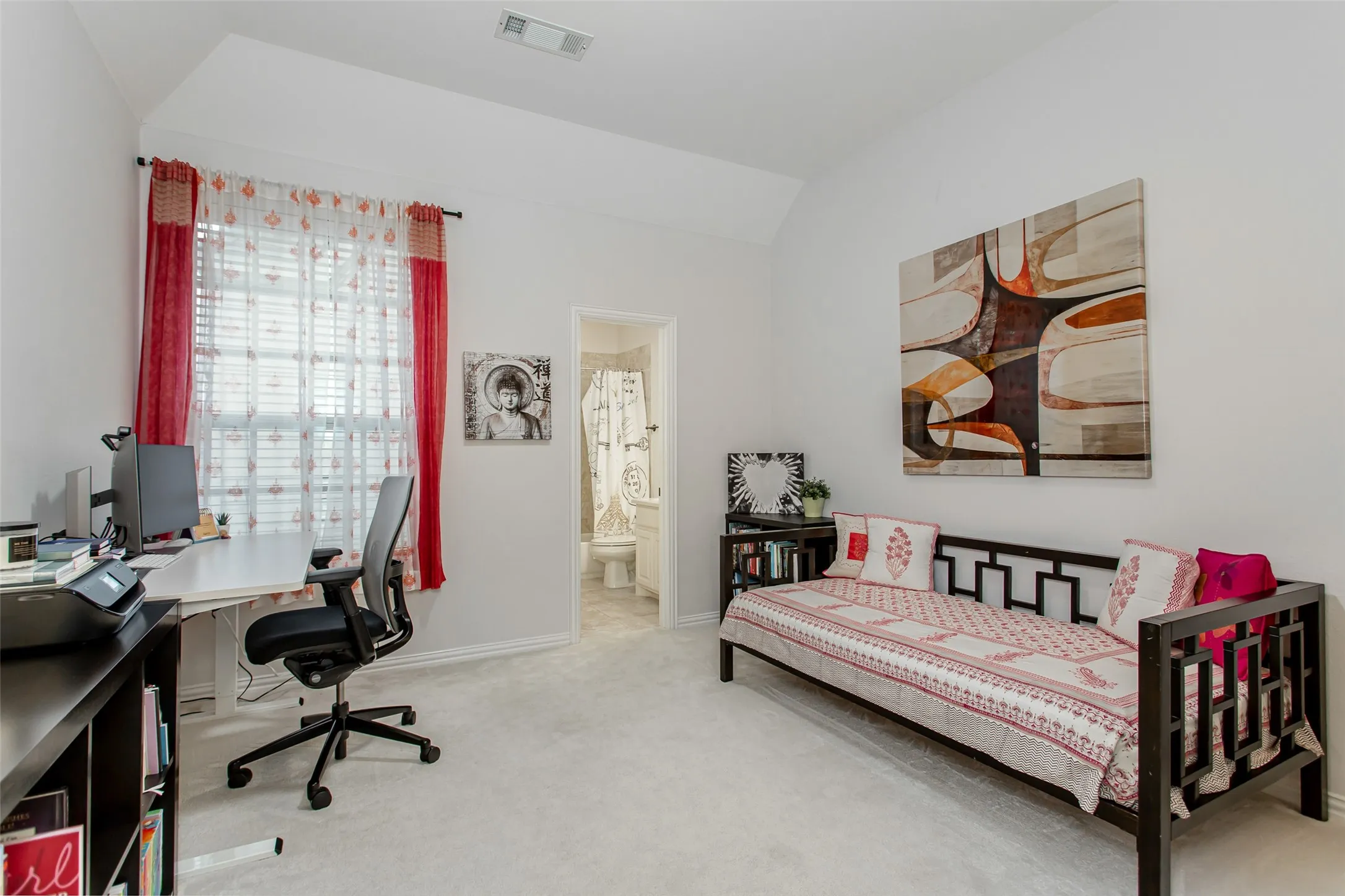 Carpeted room with a vaulted ceiling, a large window, and an en-suite bathroom with a shower-tub combination