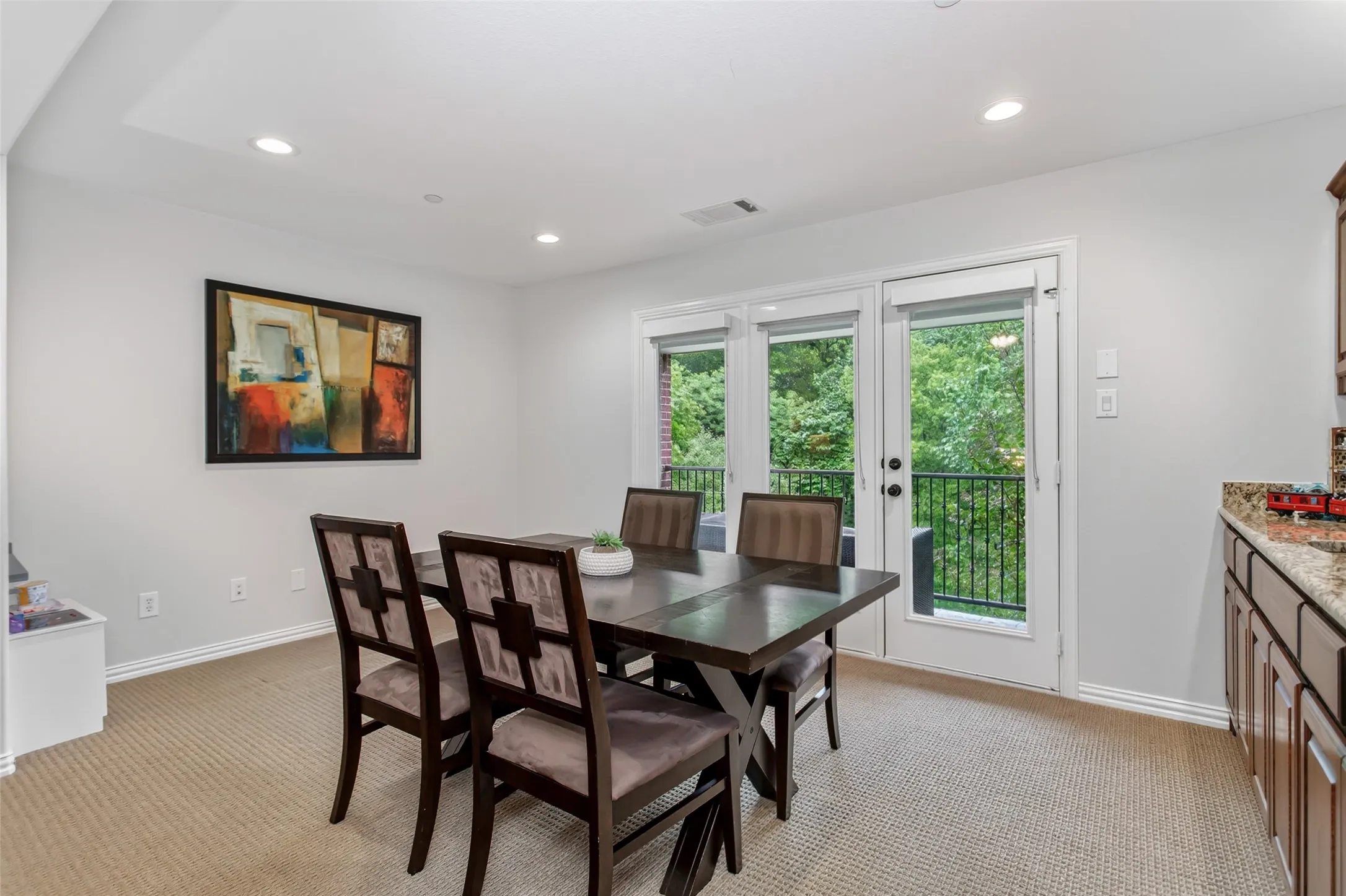 Dining area with recessed lighting and neutral carpet flooring