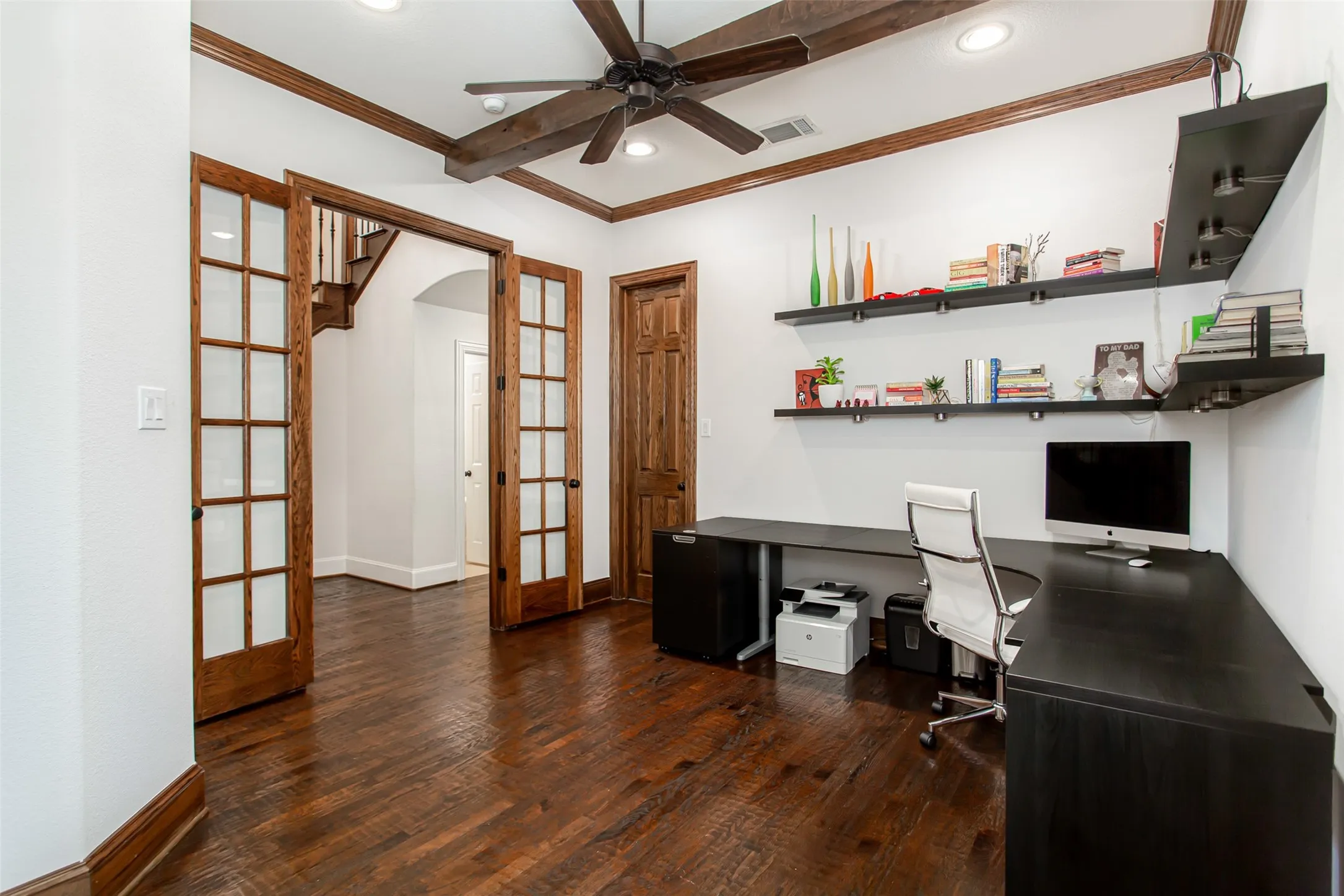 Rich wood-finish flooring with coordinating wood trim and solid core doors