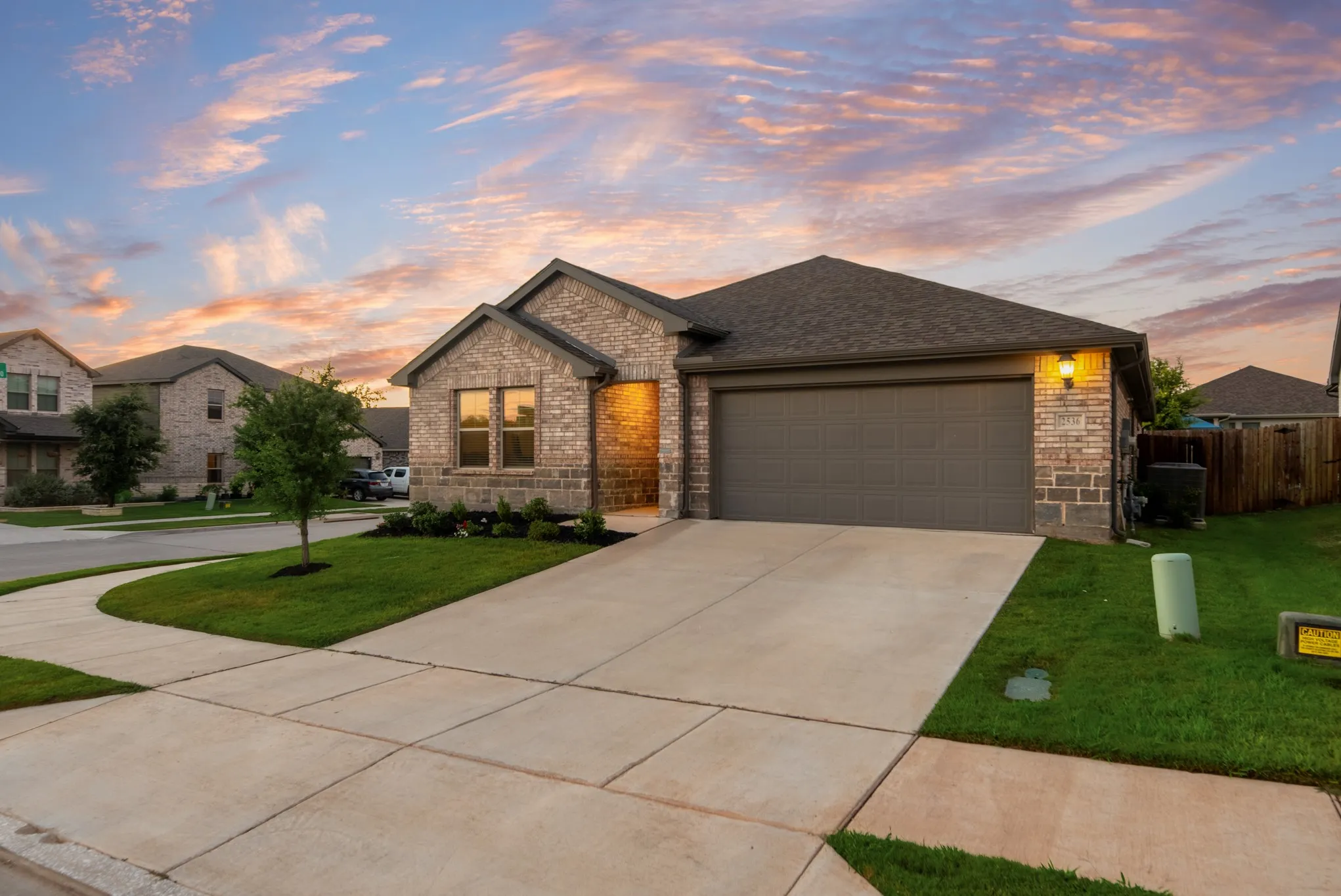 Brick and stone exterior with a dark asphalt shingle roof