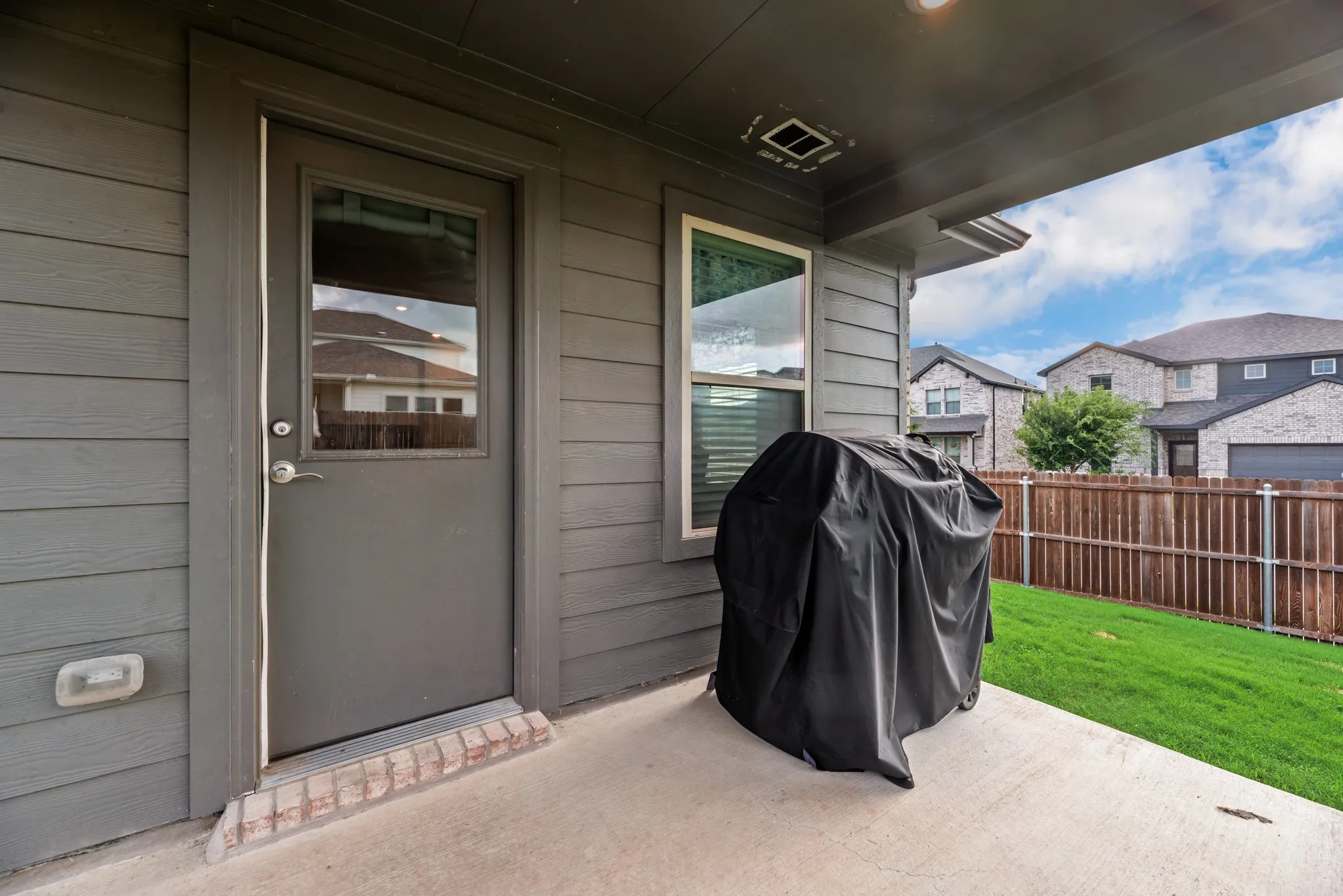 Covered patio featuring a concrete slab and painted siding