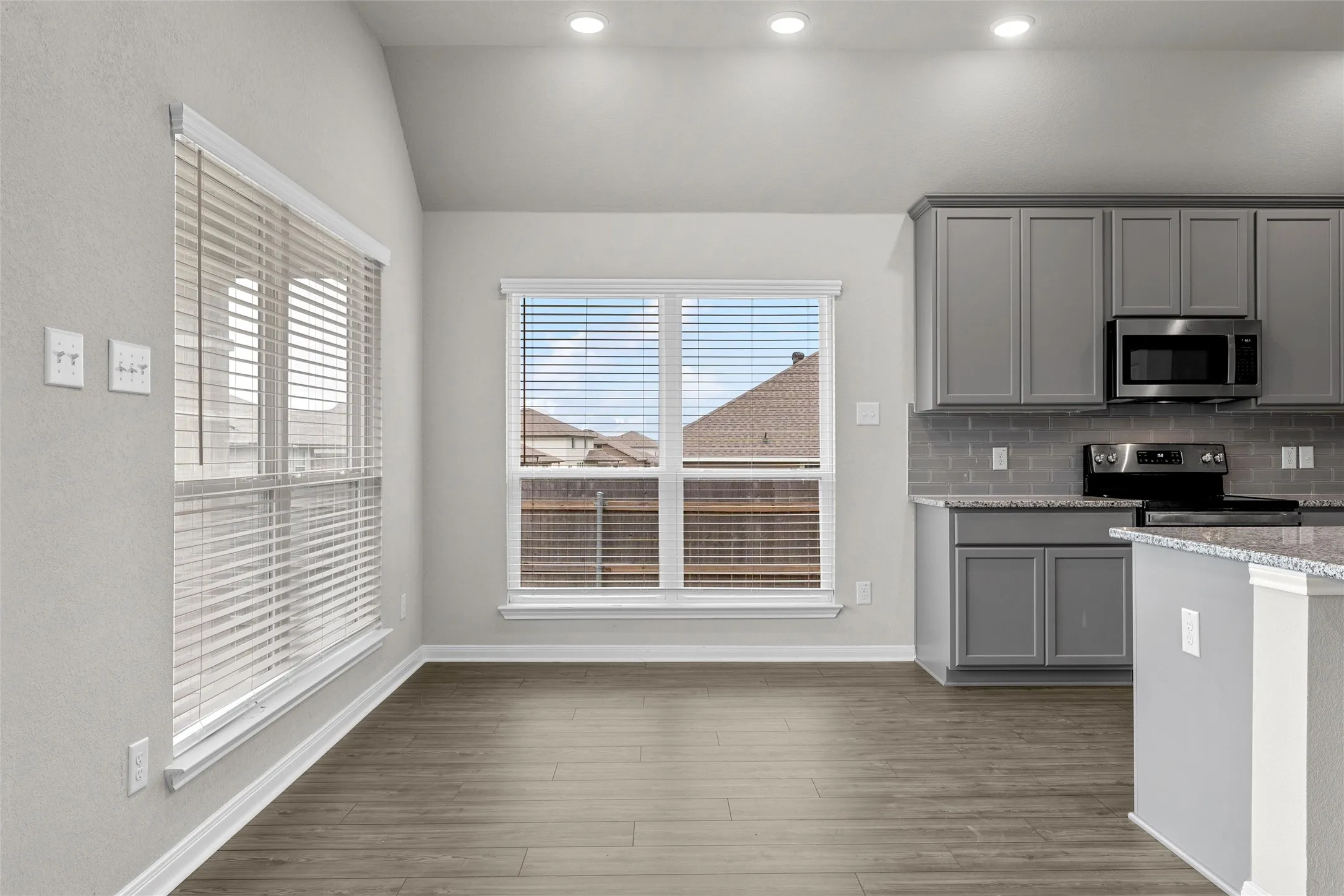 Open-concept space featuring wood-finish flooring and recessed lighting