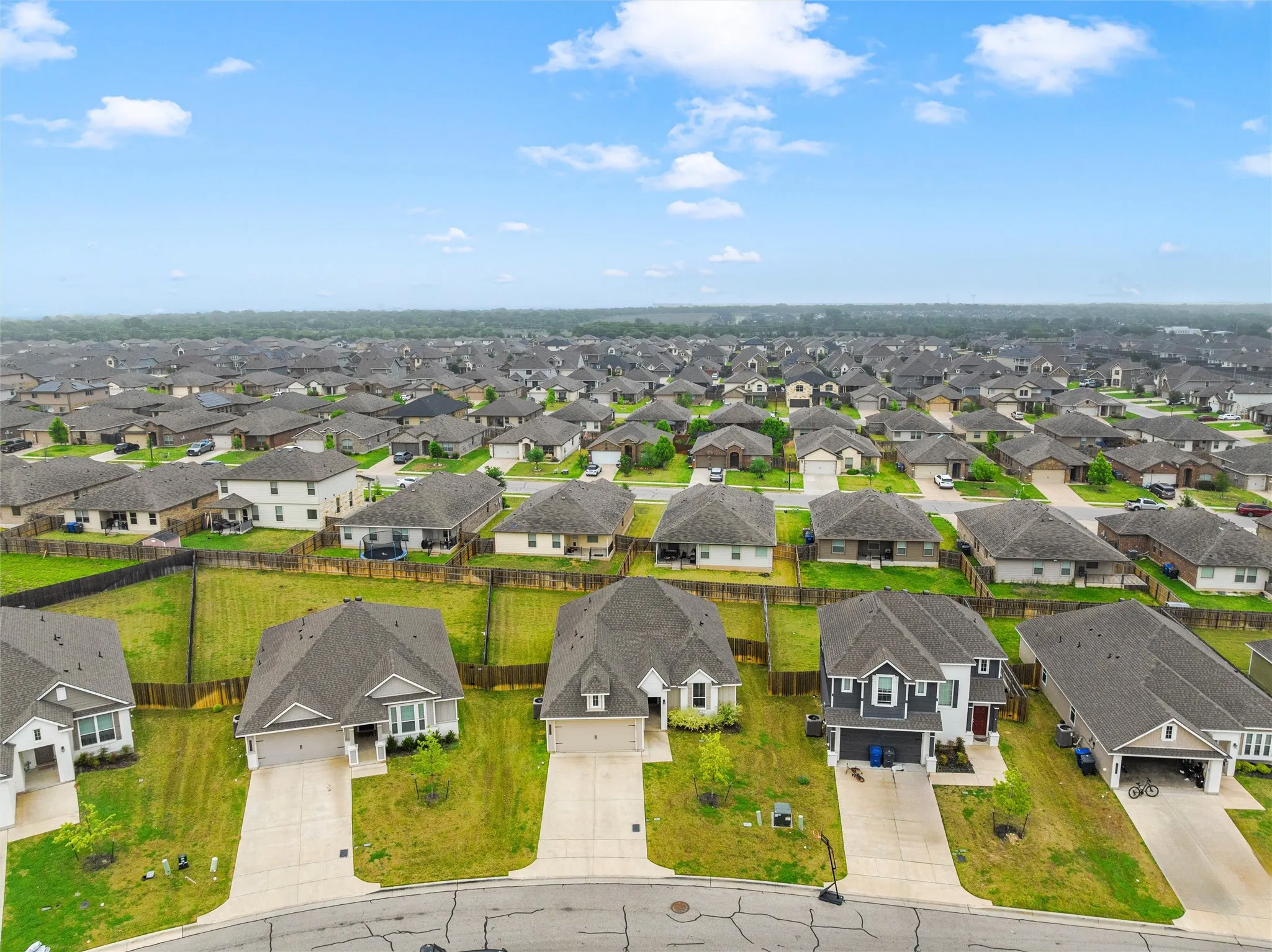 Expansive residential neighborhood featuring a variety of single-family homes, each with a private driveway and attached garage