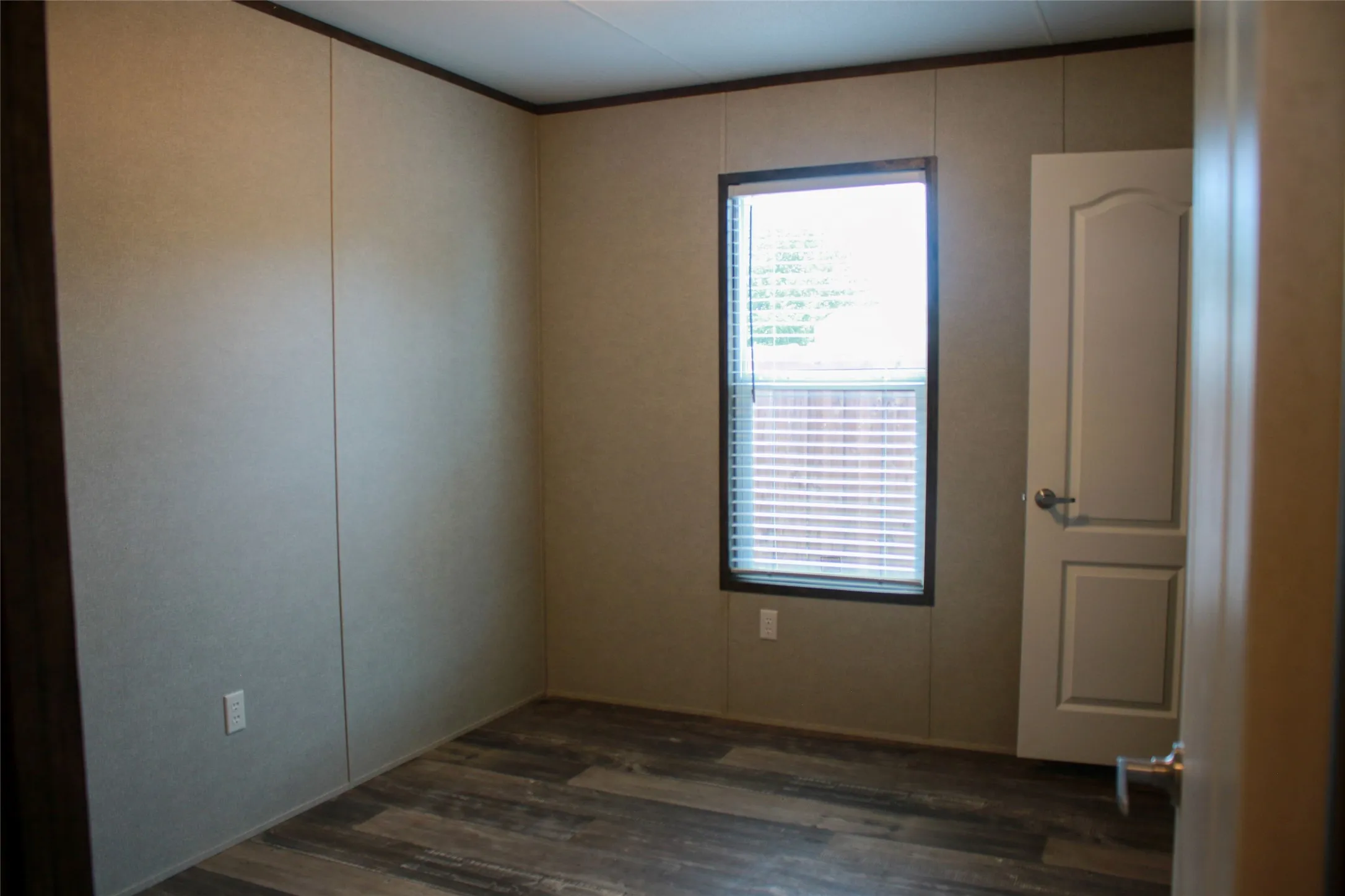 Wood-finish flooring with a neutral wall color, providing a versatile interior
