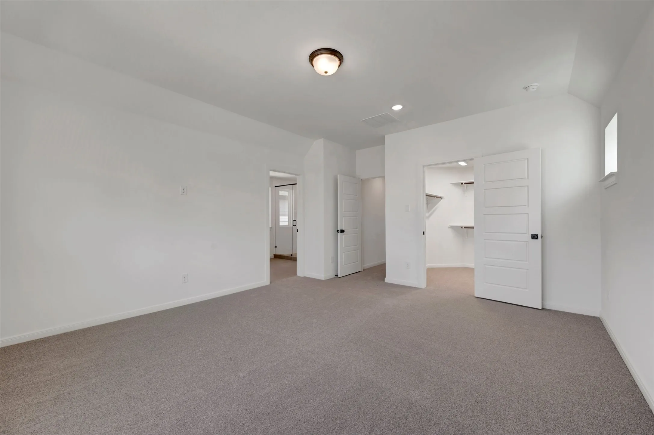 Recessed lighting, flush mount ceiling fixture, walk-in closet with built-in shelving, white paneled doors, and carpet flooring