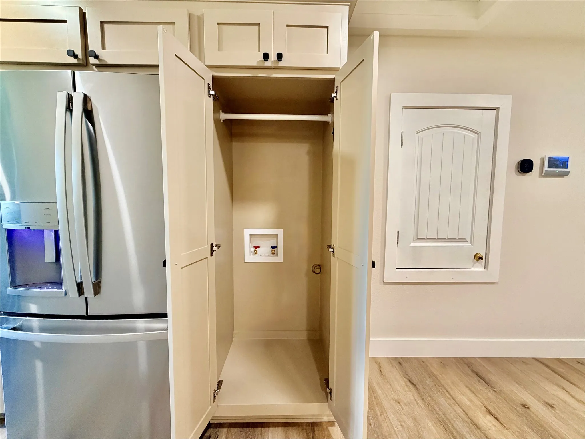 Experience ultimate convenience with an in-unit laundry closet complete with built-in overhead storage cabinets for easy organization.