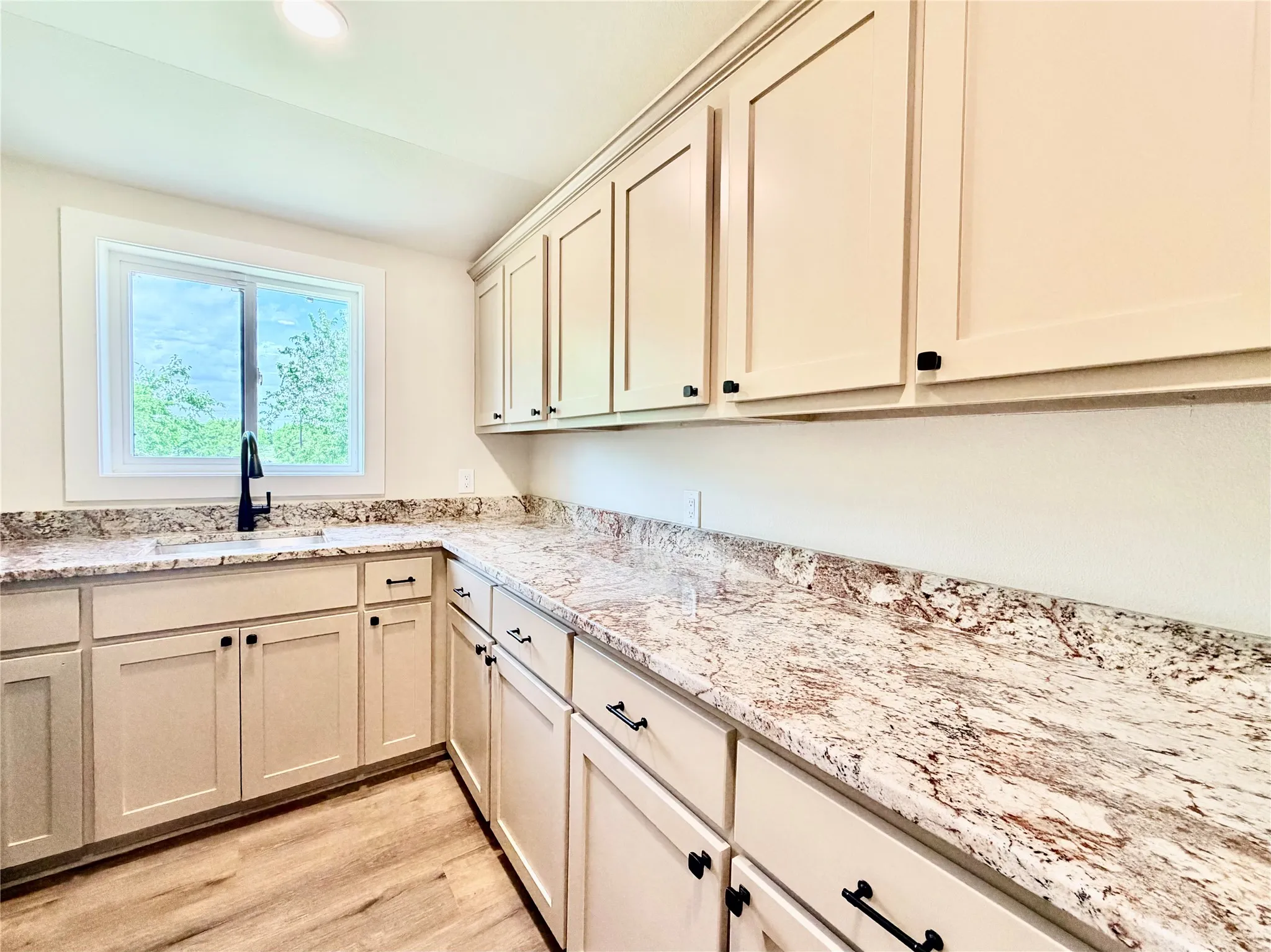 Cook and prep meals in style on stunning, premium granite countertops that beautifully accent the bright, clean cabinetry.