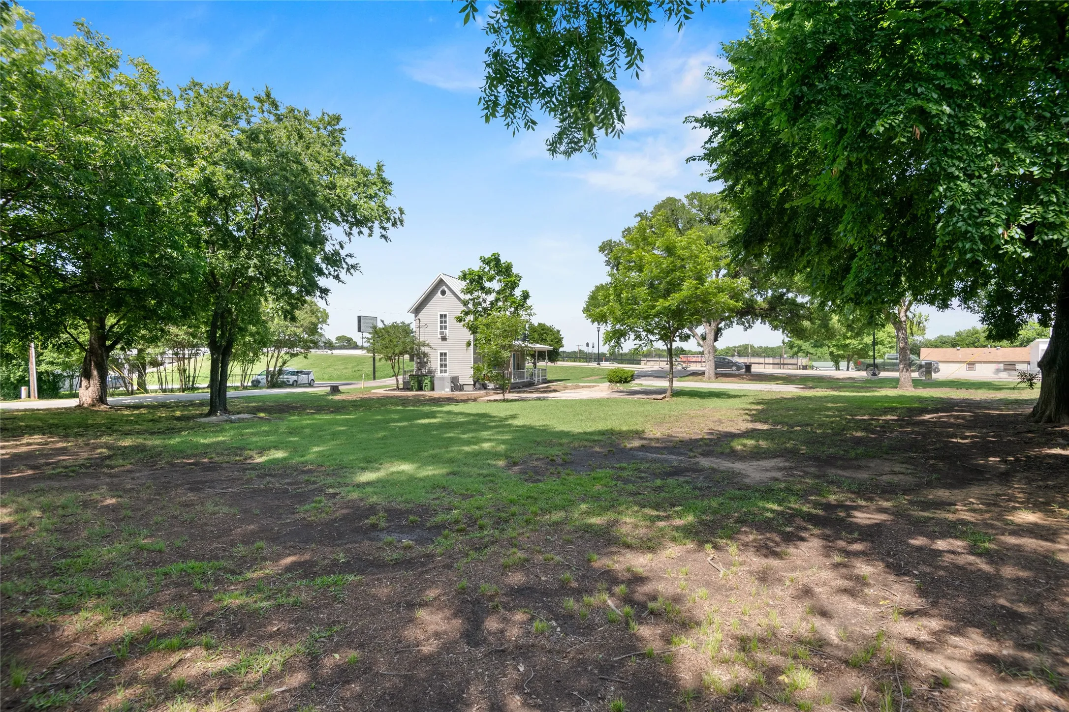 The property features a spacious yard with mature trees and a well-maintained lawn.
