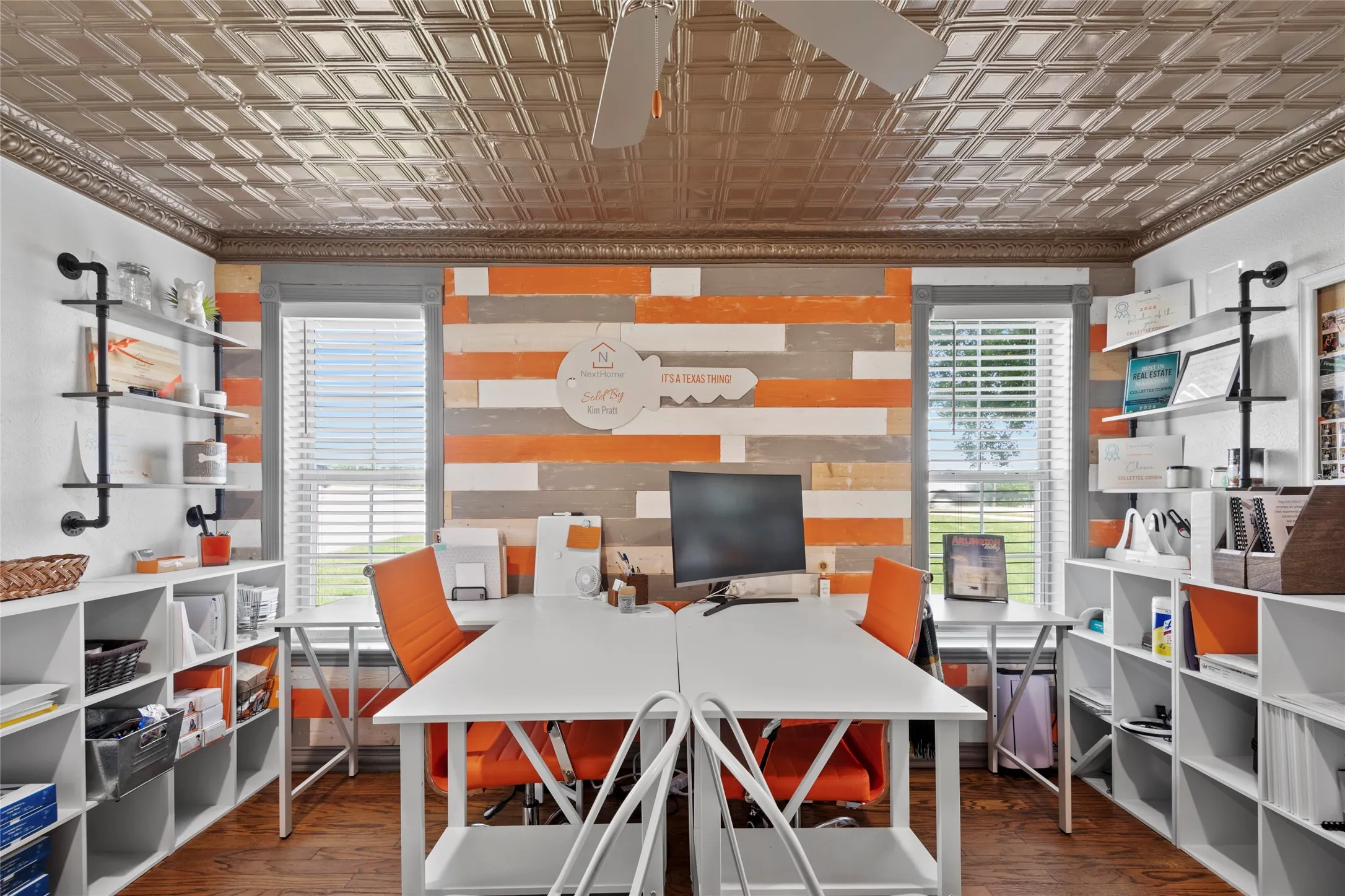 This dedicated office space features hardwood floors, a decorative ceiling, and two windows providing natural light.