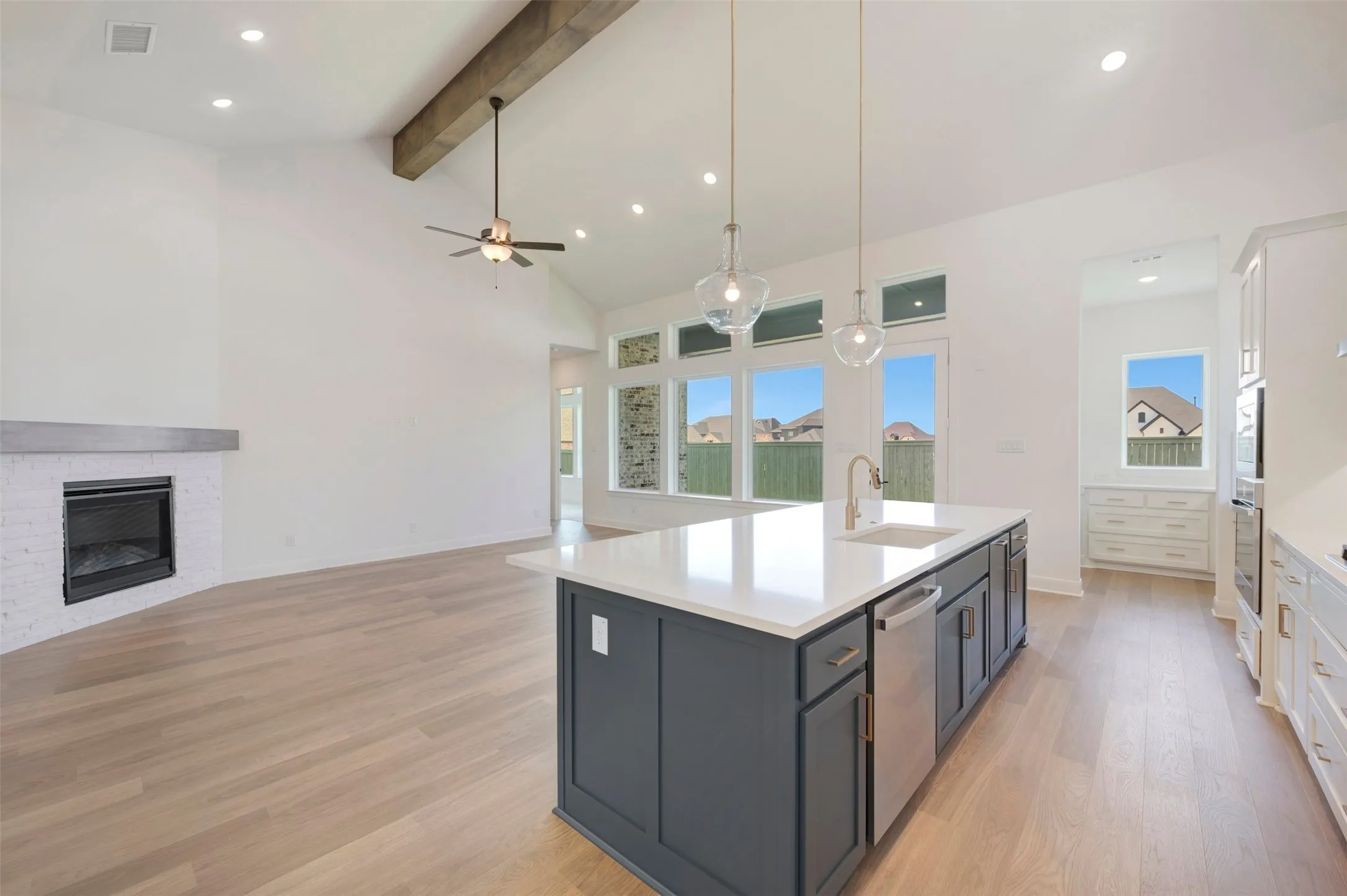 Vaulted ceiling with an exposed wood beam, recessed lighting, and a modern ceiling fan