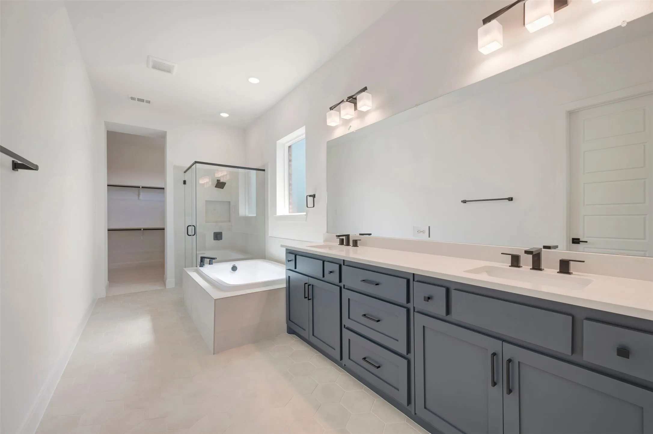 Dual vanity with white countertops, undermount sinks, and matte black fixtures