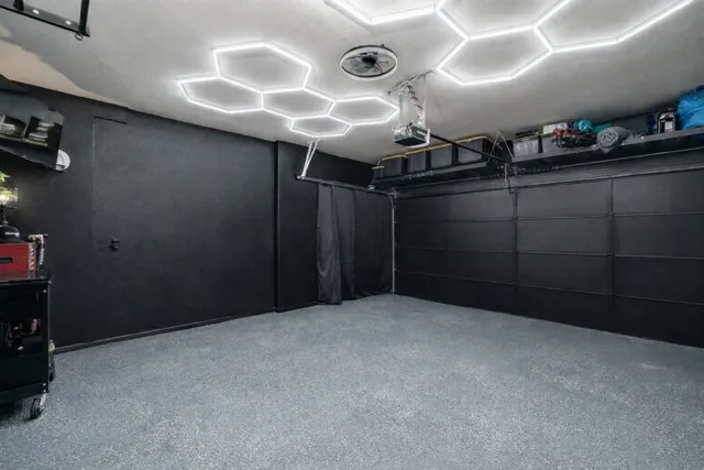 Wait until you see this garage in person! Epoxy Floors, ceiling mounted Storage racks that stay with home, TV mount, custom lights, wall unit for AC - turn this into a flex space for gym, workshop or more!