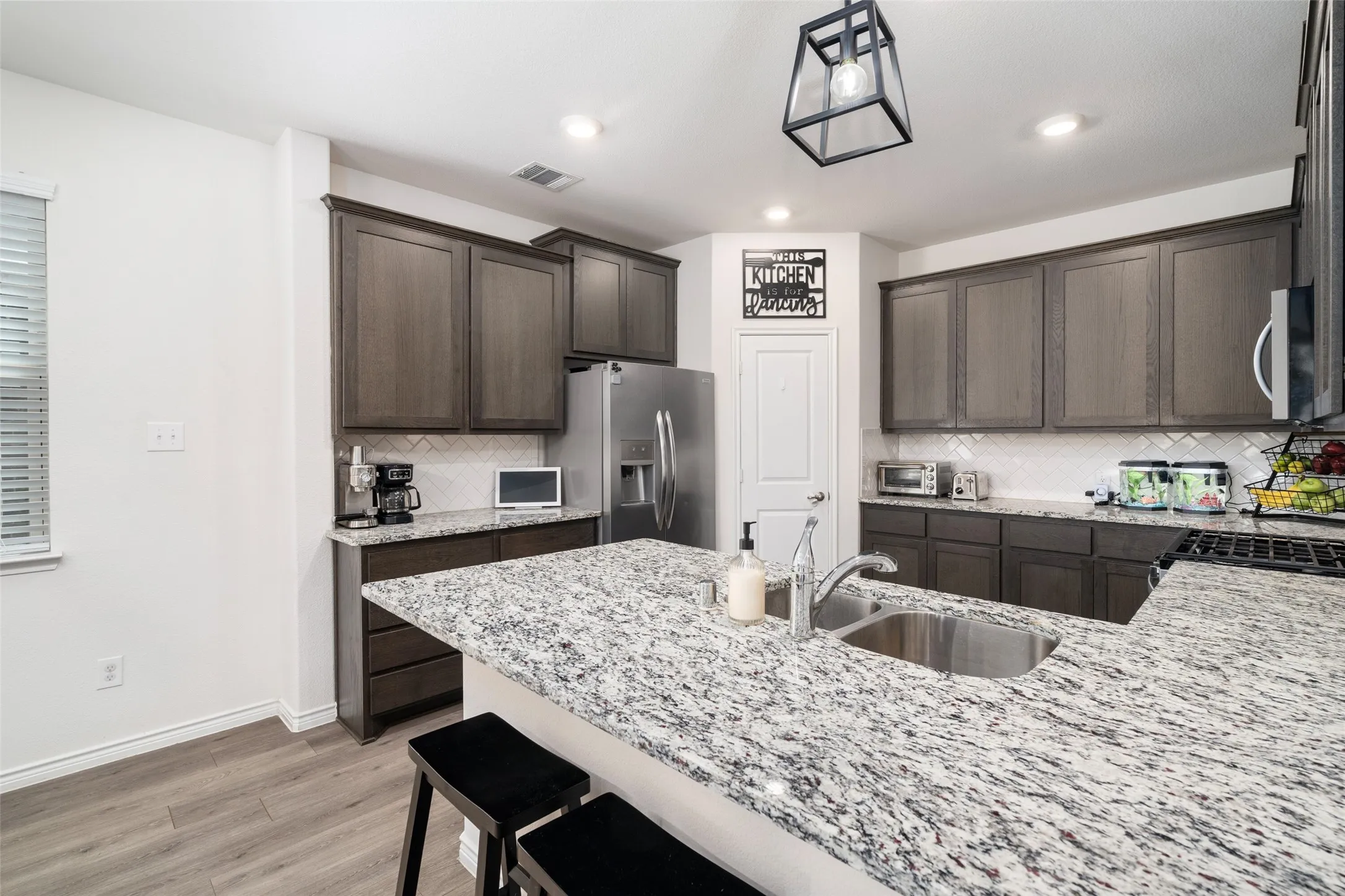 Kitchen with Ample Storage cabinets, walk in pantry, Granite Counters, Stainless Appliances, Gas Range.