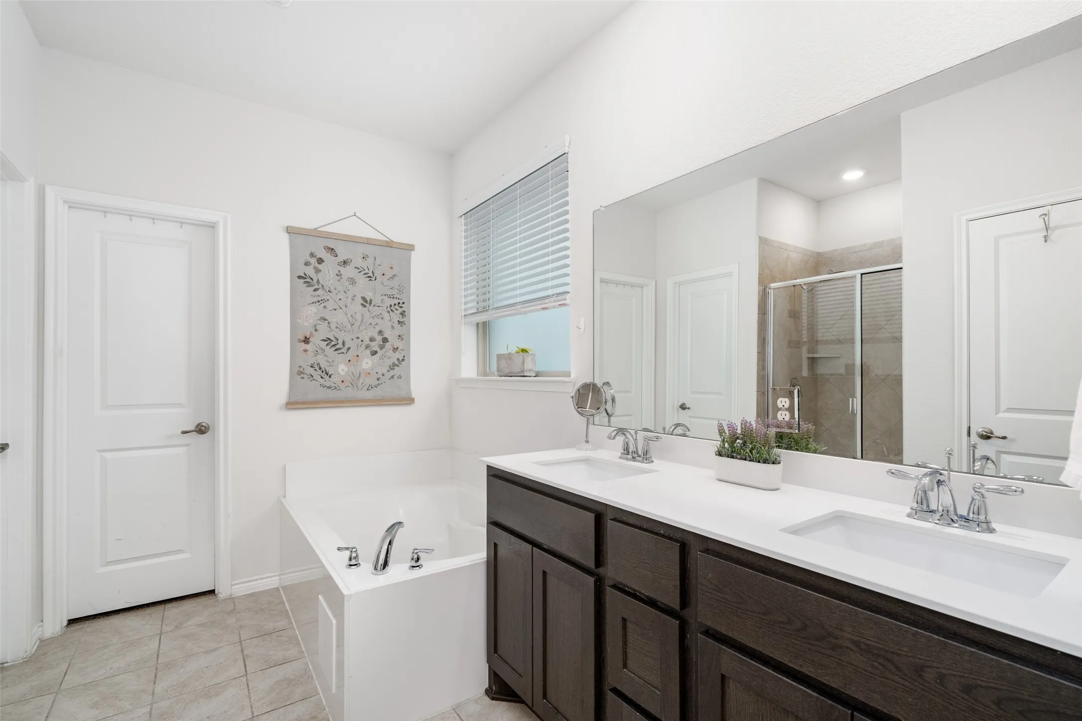 Primary Bathroom features dual sink vanity, garden tub, separate walk in shower and walk in closet!