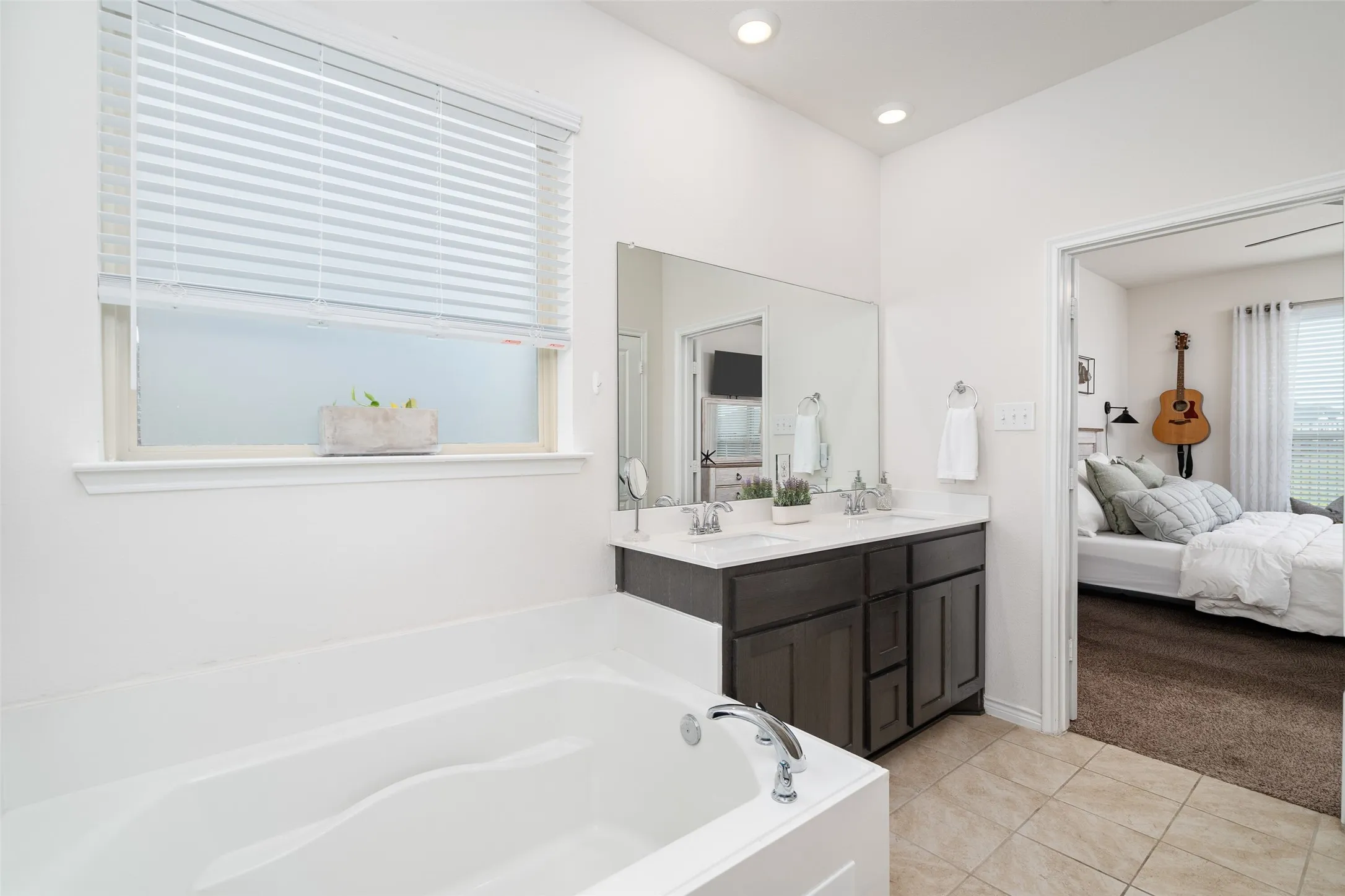 Primary Bathroom with large walk in closet, separate shower, dual sink vanity.