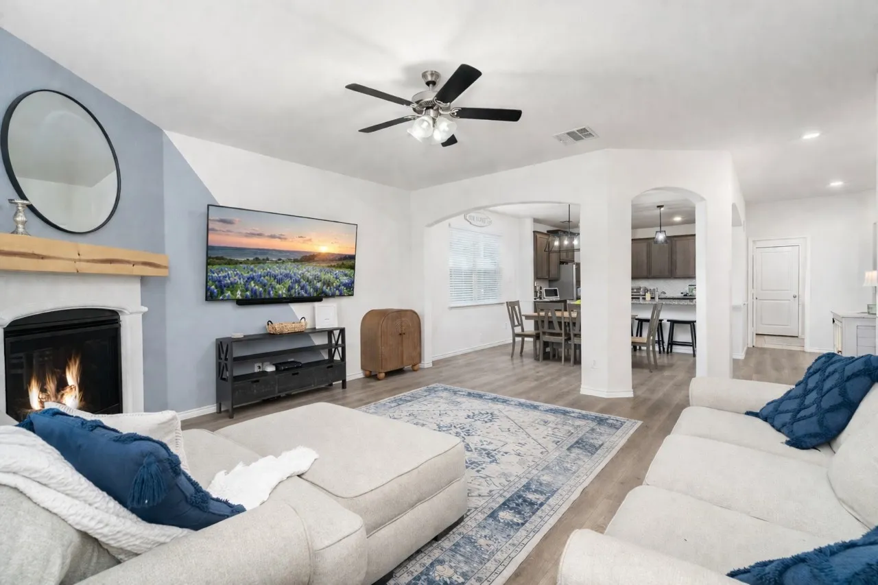 Seamless flow between living and dining spaces with gas fireplace.