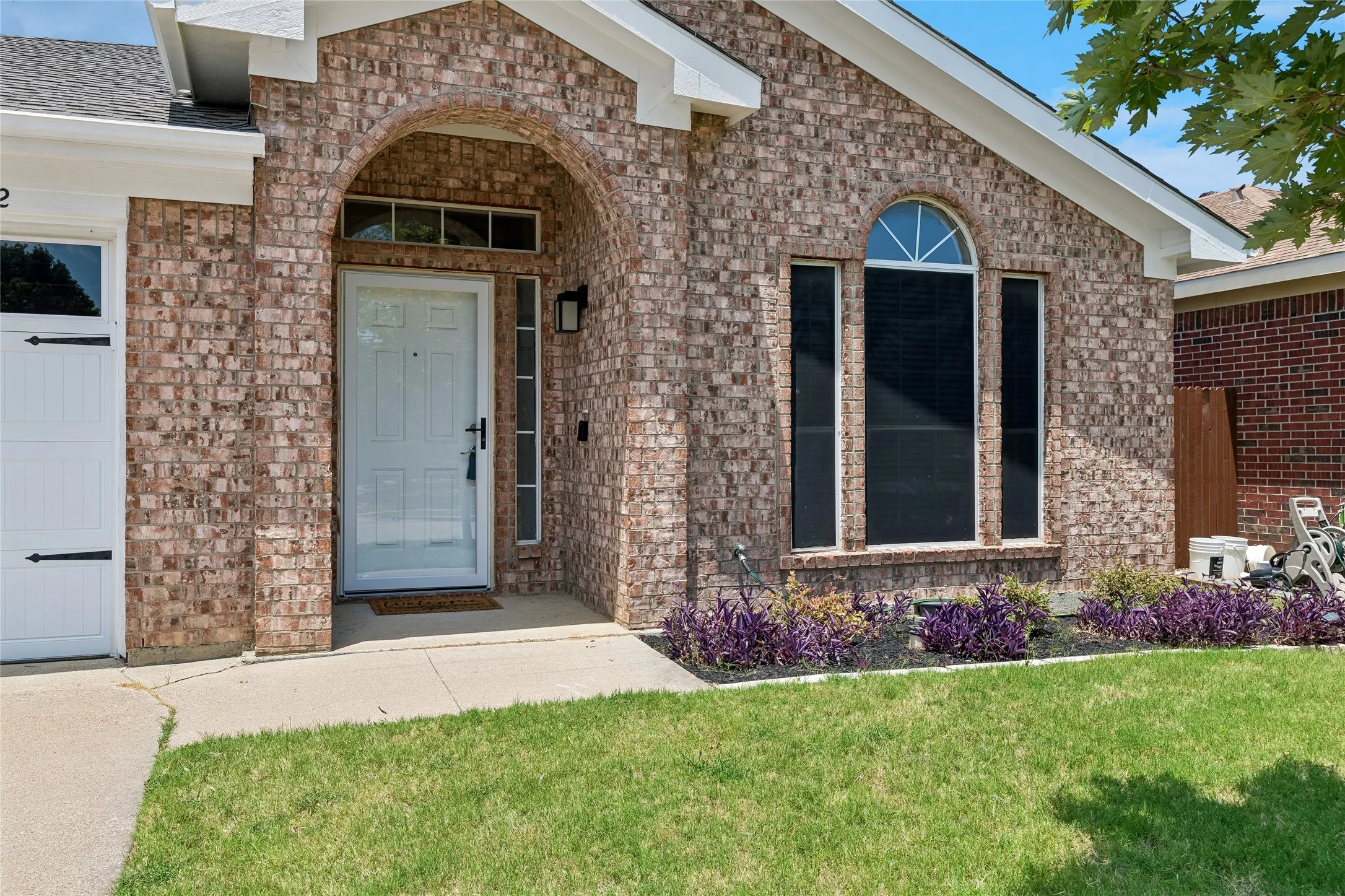Entry features a storm door & nice front door.