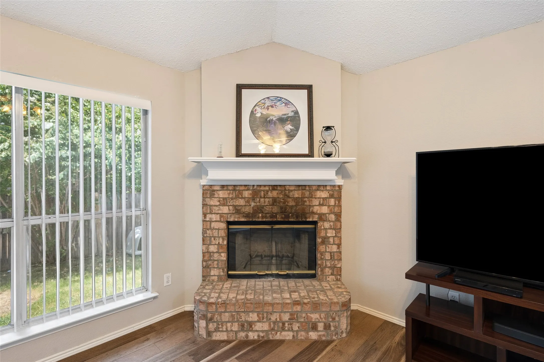 Another view of the brick wood-burning fireplace.