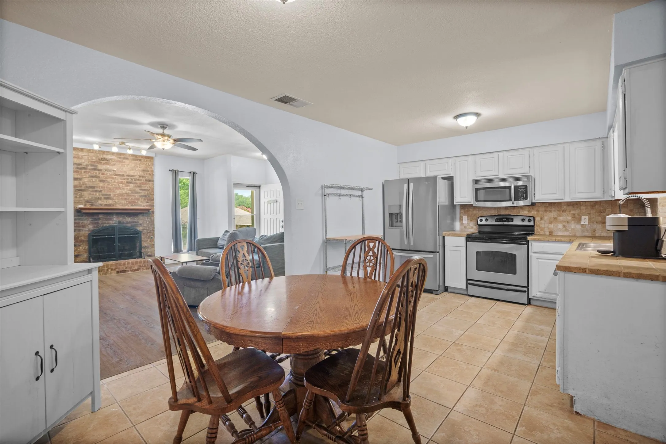Kitchen with tile flooring and white cabinetry