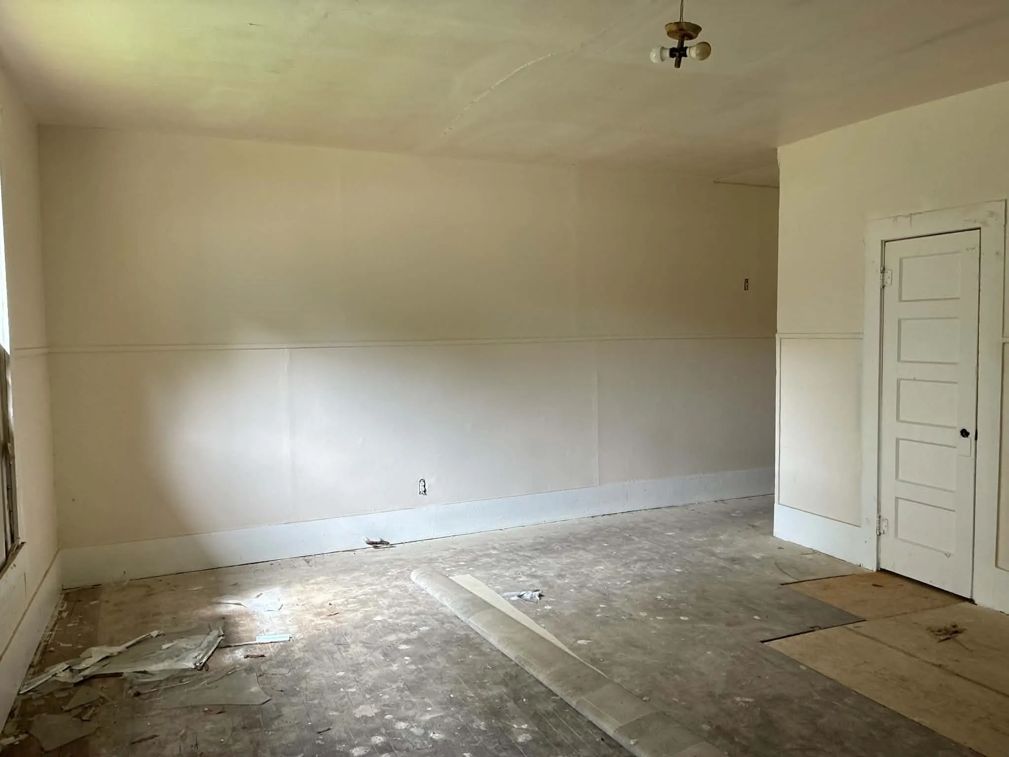 Spacious interior room with light-toned walls and high ceilings