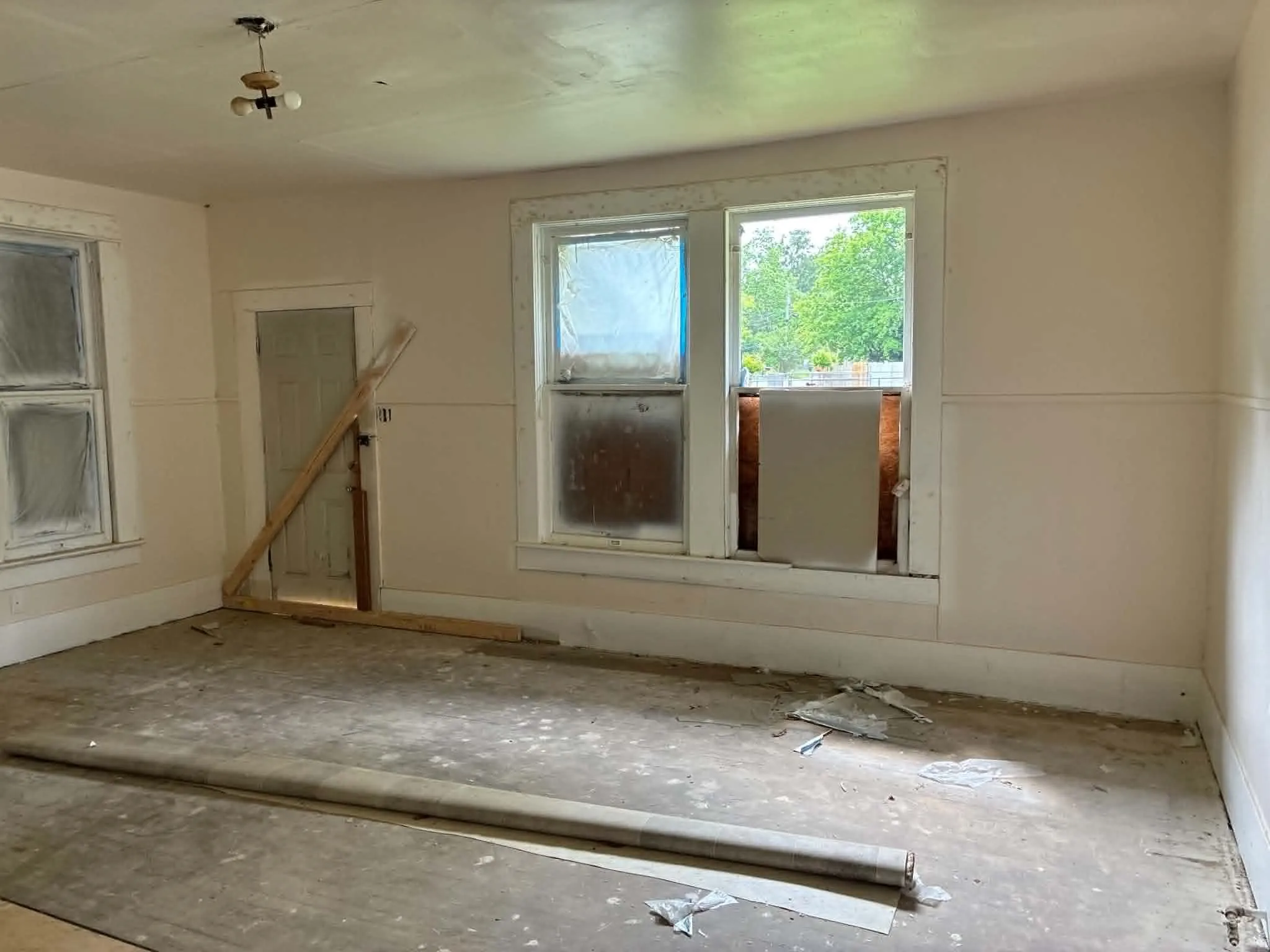 Interior room featuring multiple windows and a single door
