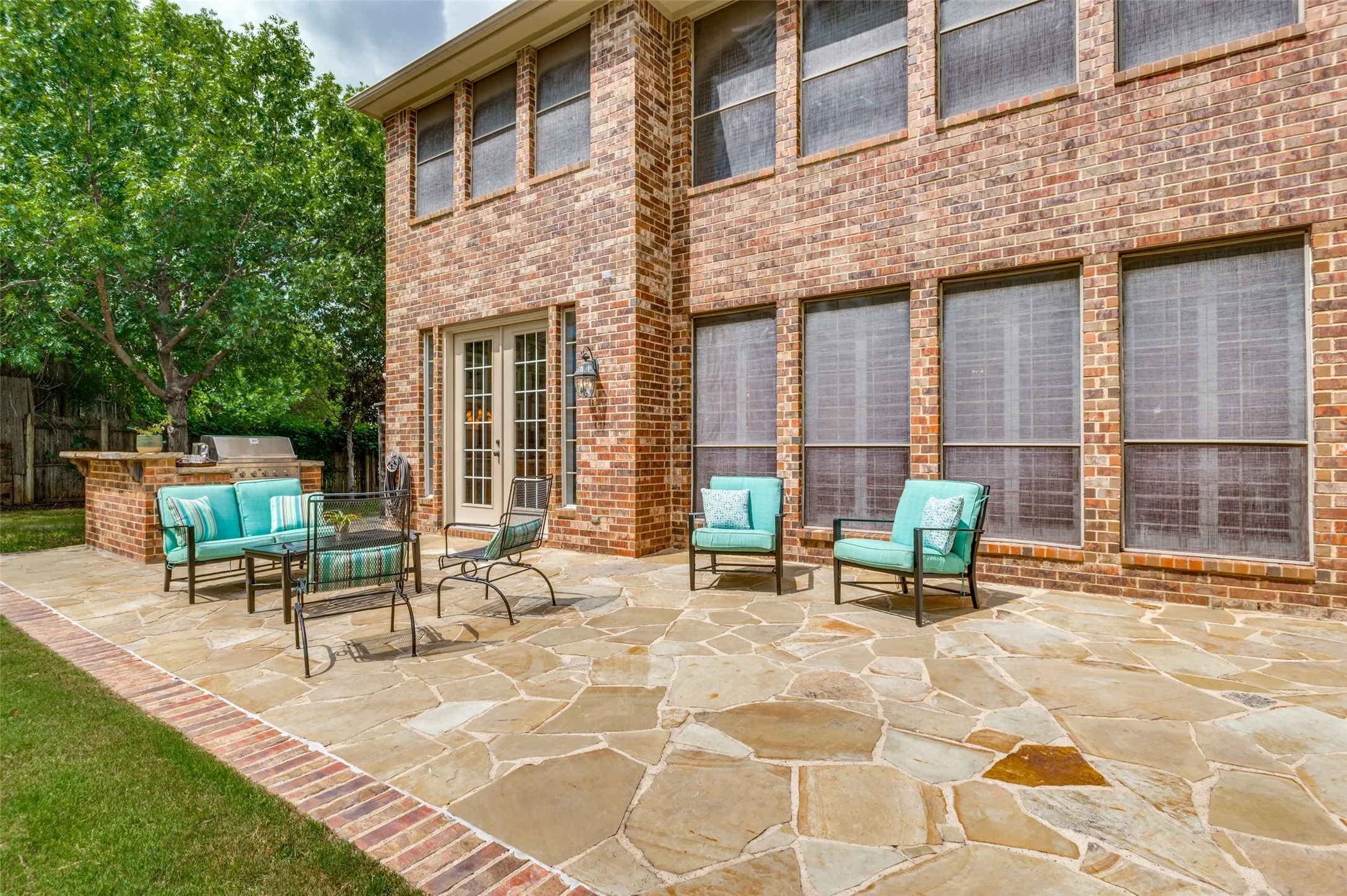 Huge back patio solar screens and grill area