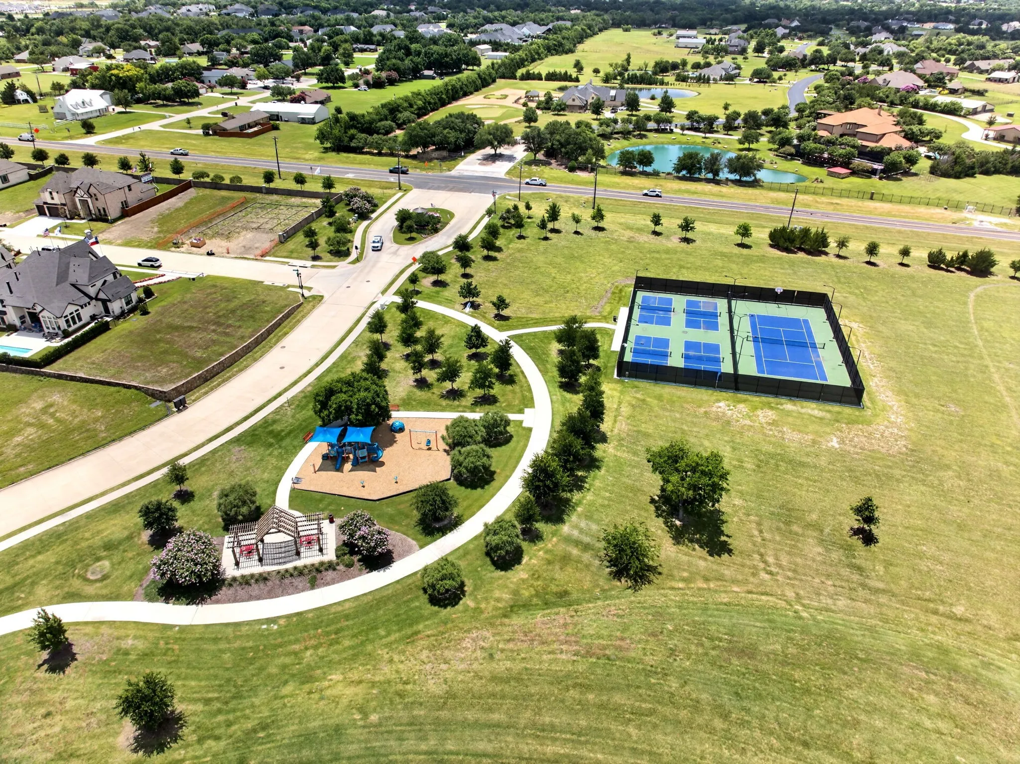 Community amenities featuring multiple tennis courts, a children's playground, and walking paths