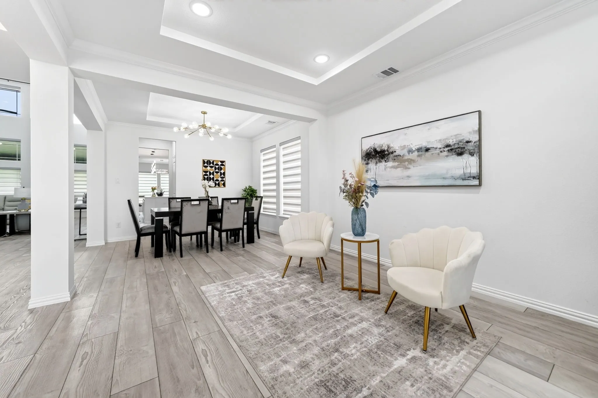 Spacious open-concept living area featuring light wood-finish flooring