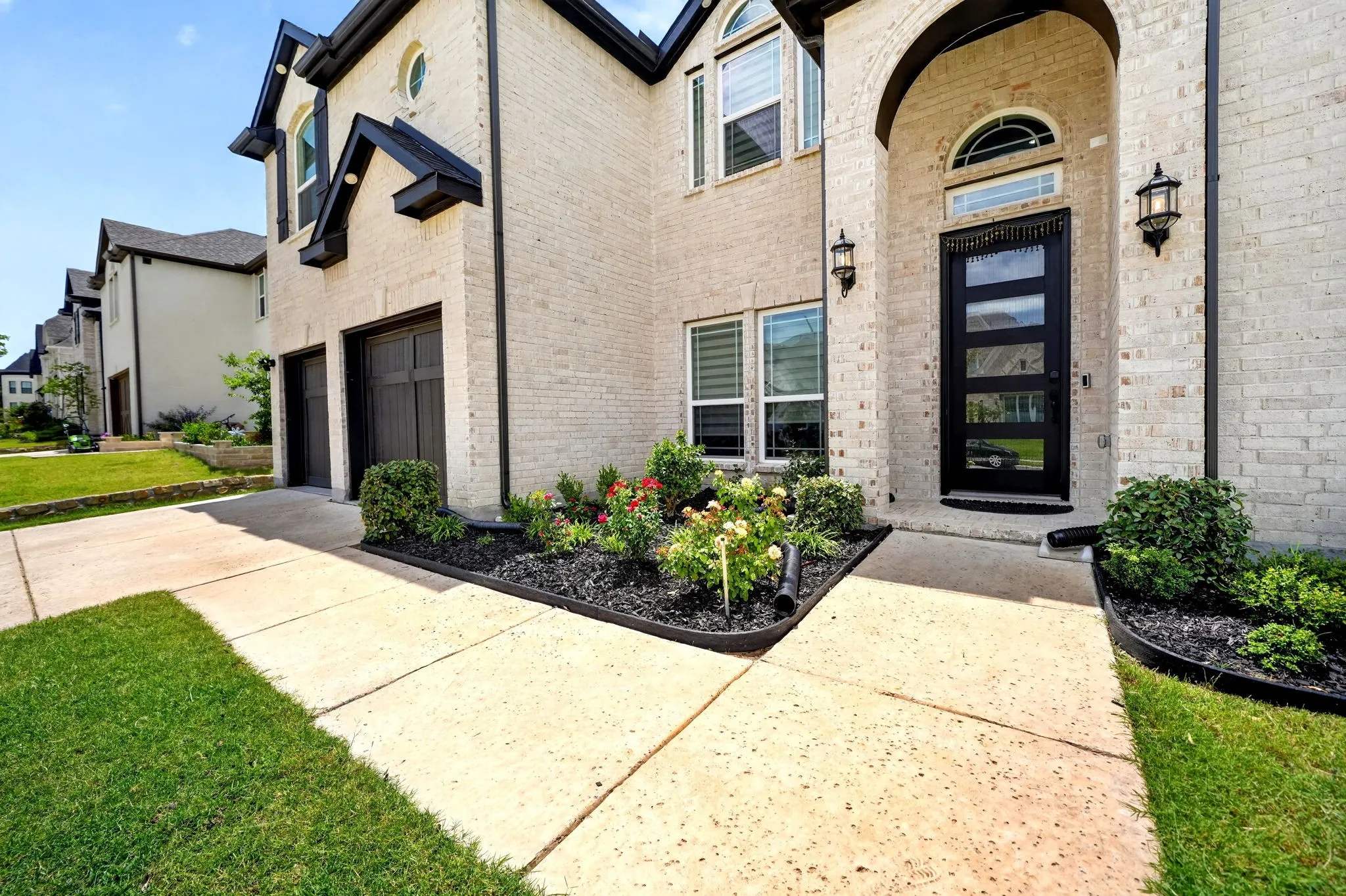 Traditional brick exterior with dark trim accents and an arched entry