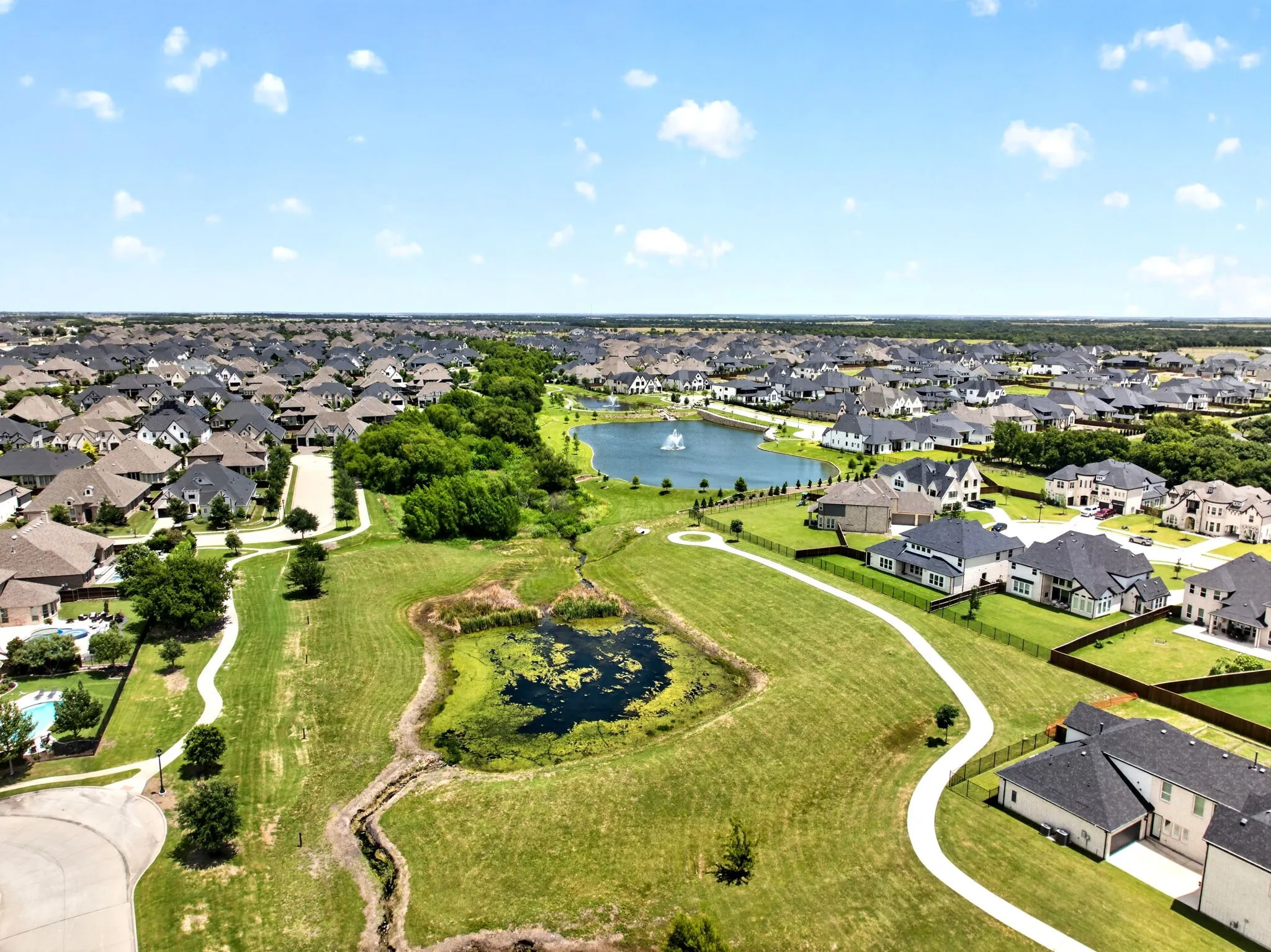 Expansive aerial perspective showcasing a residential community with numerous homes