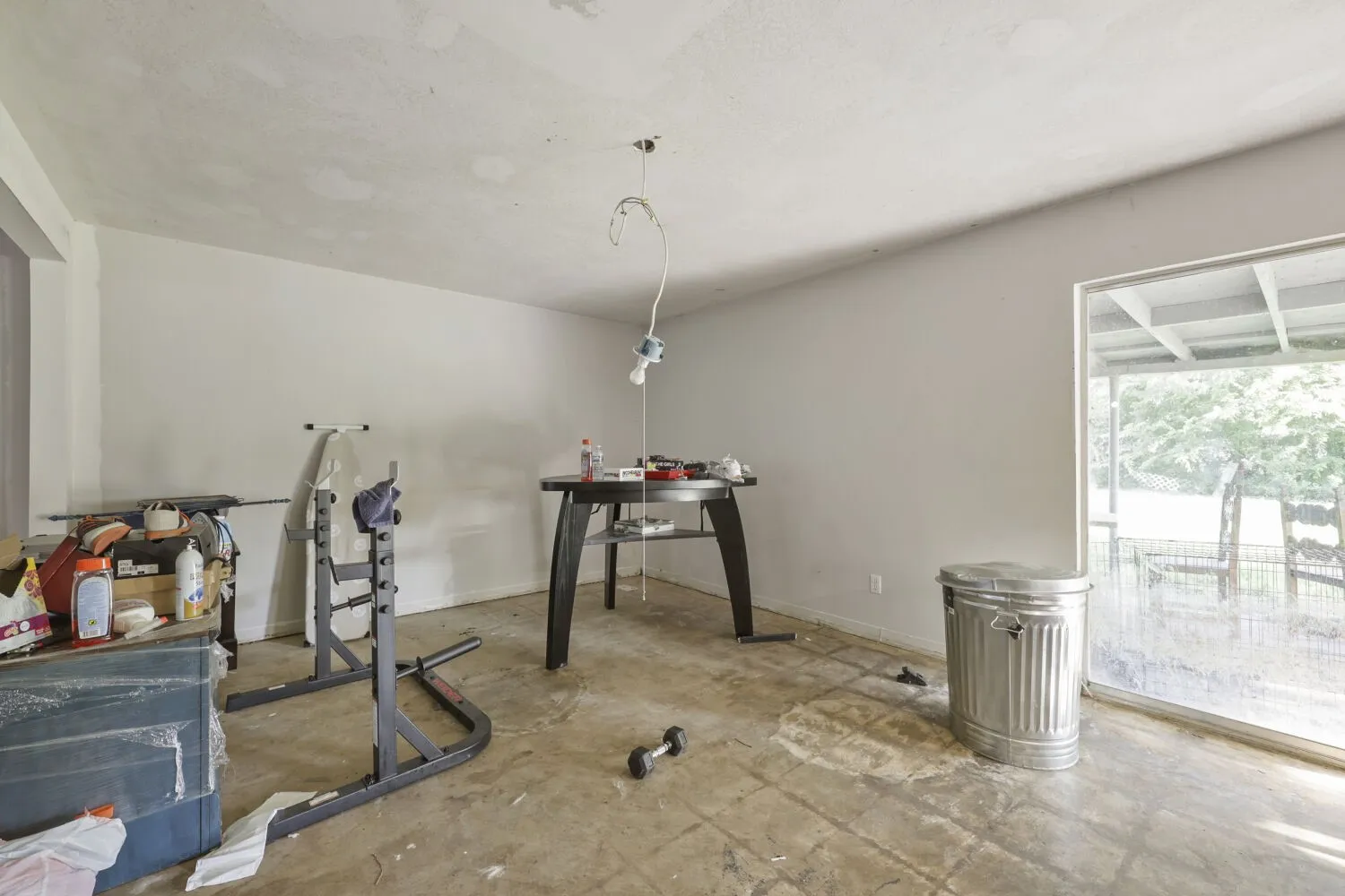 Neutral-toned walls and bare concrete flooring define this interior space