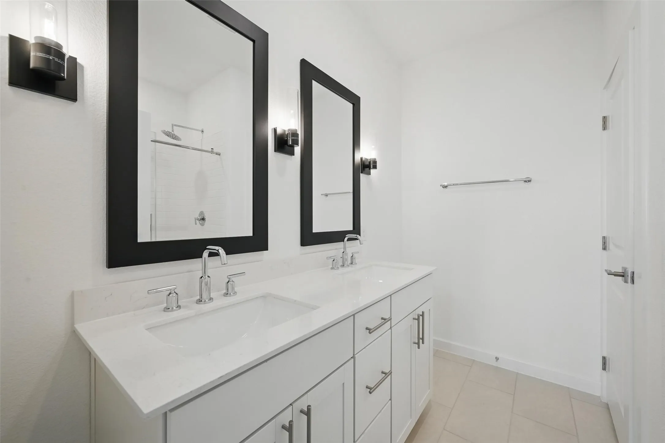 Dual vanity with undermount sinks, white cabinetry, and a light-toned countertop