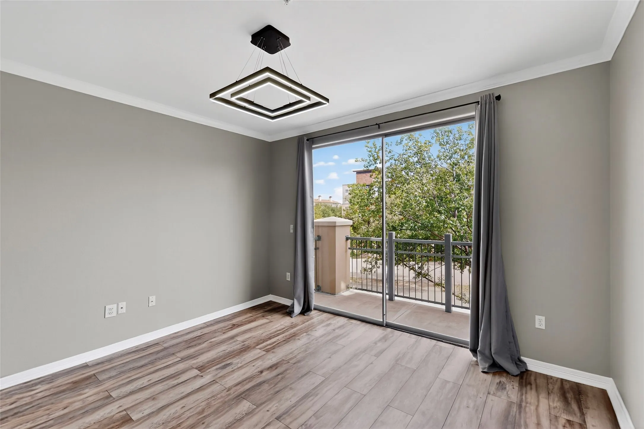 Unfurnished room with crown molding and wood finished floors