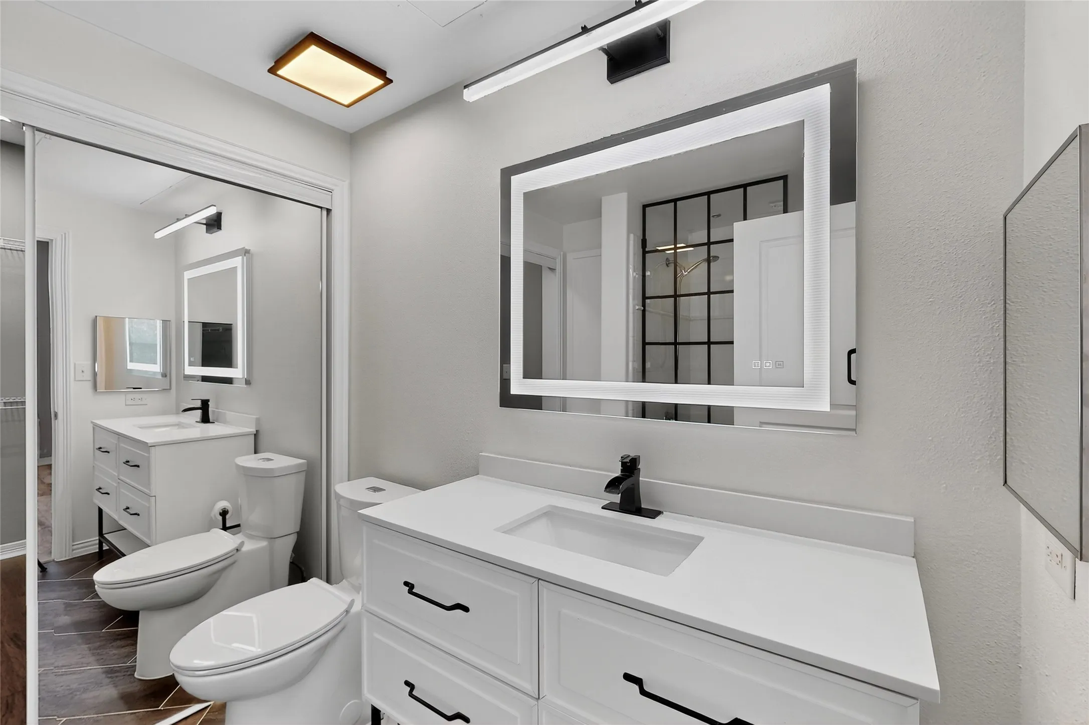 Bathroom featuring vanity, wood finished floors, and a bidet