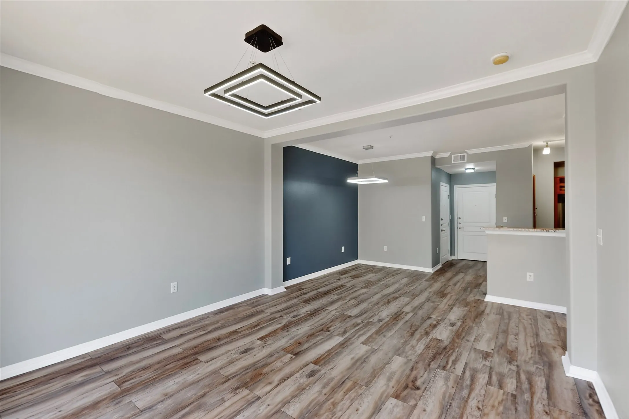 Spare room featuring wood finished floors and ornamental molding