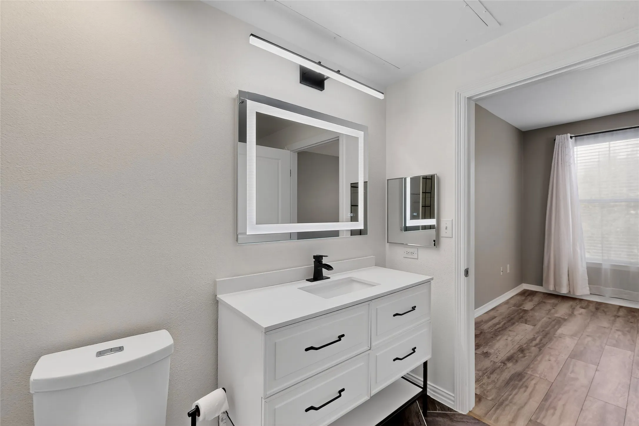 Bathroom with vanity and wood finished floors