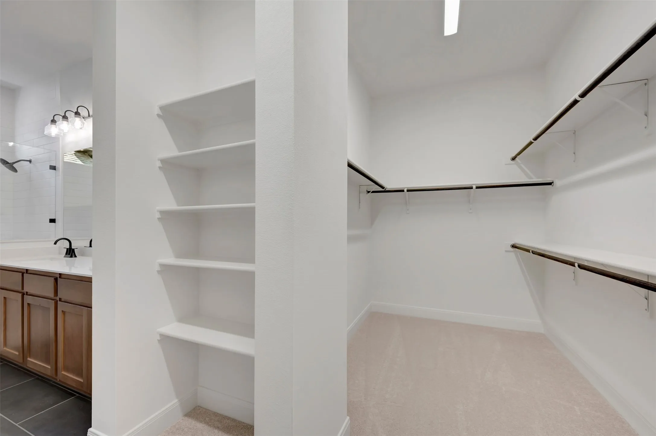 Built-in shelving, extensive closet rods and shelving, and plush carpet flooring