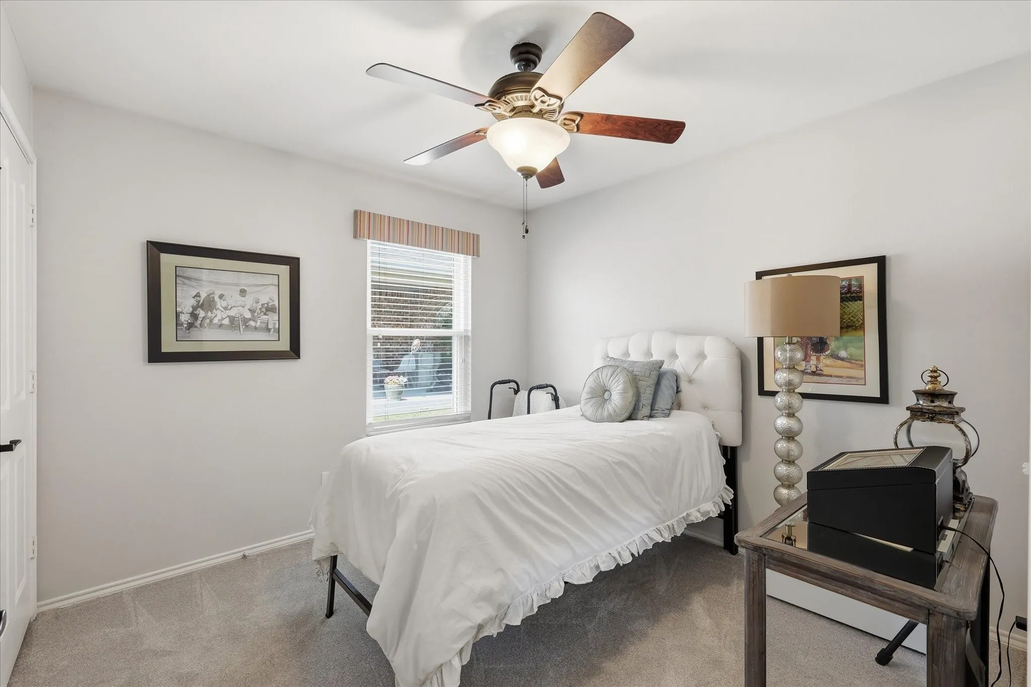 Bedroom featuring neutral wall paint, gray carpet, and a ceiling fan with light fixture